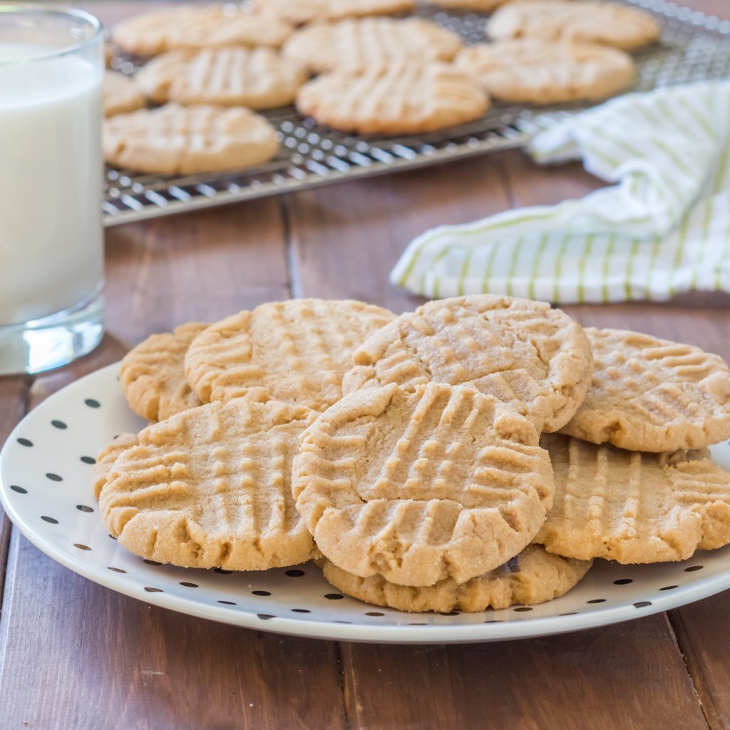 white plate with black polka dots filled with classic gluten free peanut butter cookies made with gluten free flour