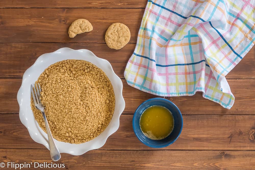 overhead view of ingredients to make gluten free vegan cookie crumb crust you need cookie crumbs and melted vegan butter