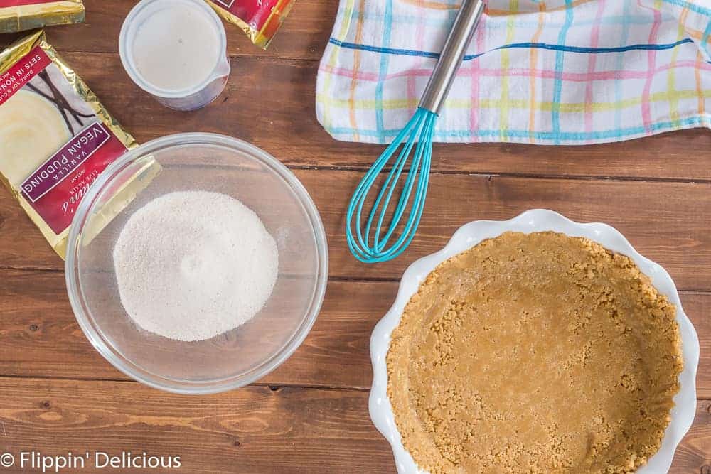 vegan pudding mix and milk in a bol and measuring cup, ready to make some vegan pudding pie filling