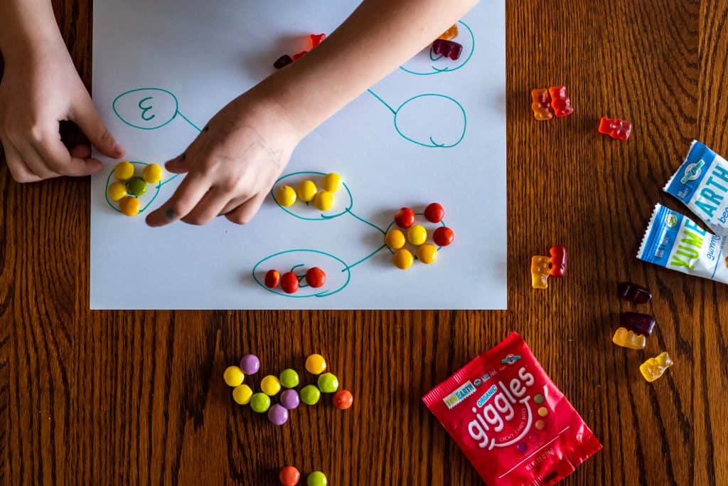 small hands arranging candy in number bonds