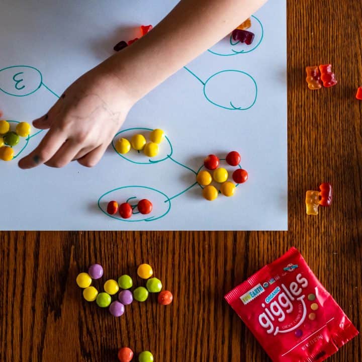 small hands arranging candy in number bonds