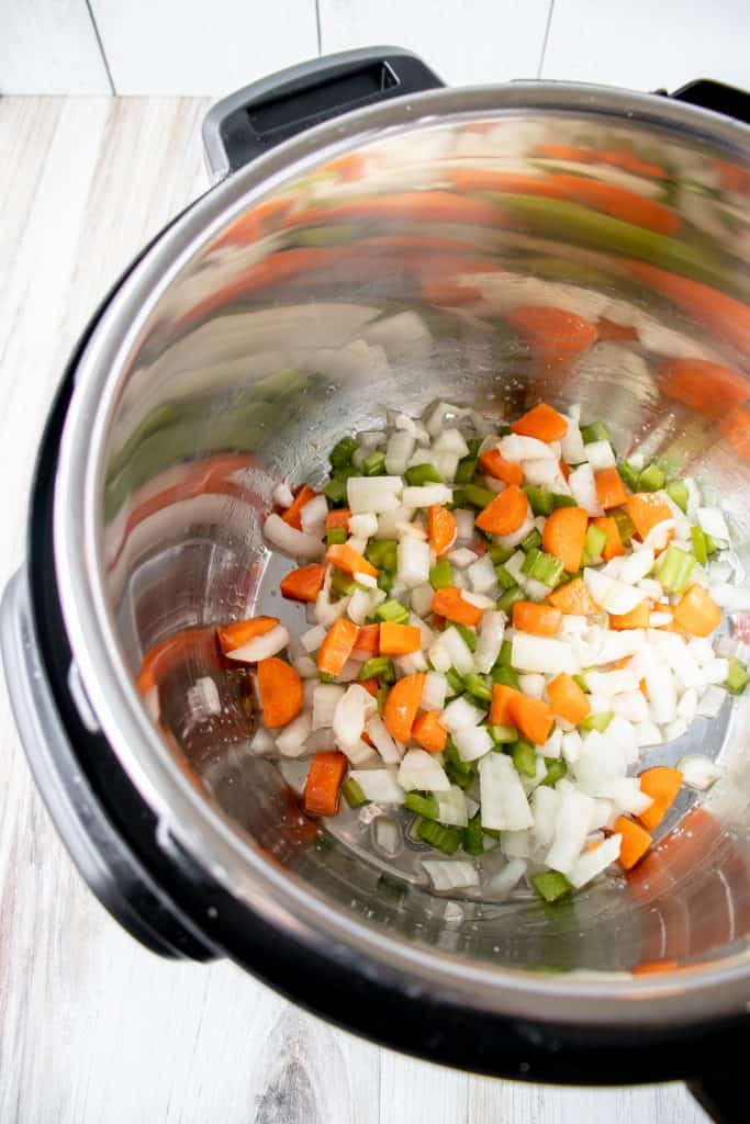mirepoix (diced celery, onion, and carrots) in the bottom of an instant pot pressure cooker