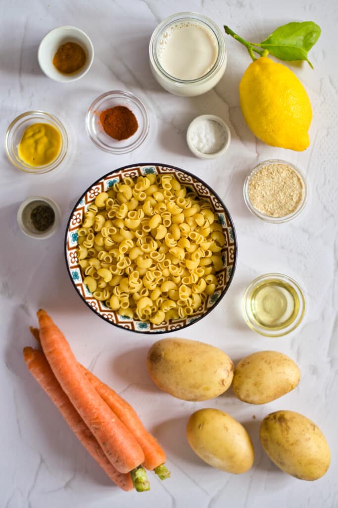 ingredients to make gluten free vegan mac and cheese on a marble table