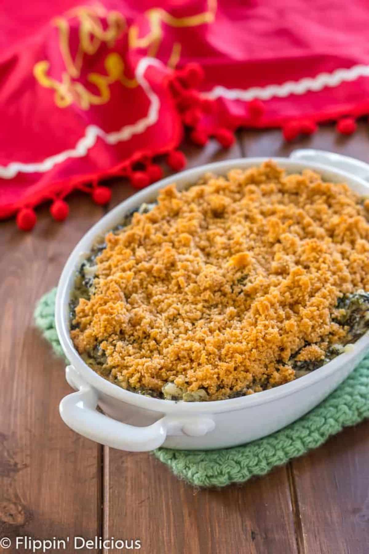 Gluten-Free Spinach Artichoke Dip With Breadcrumbs in a white casserole.