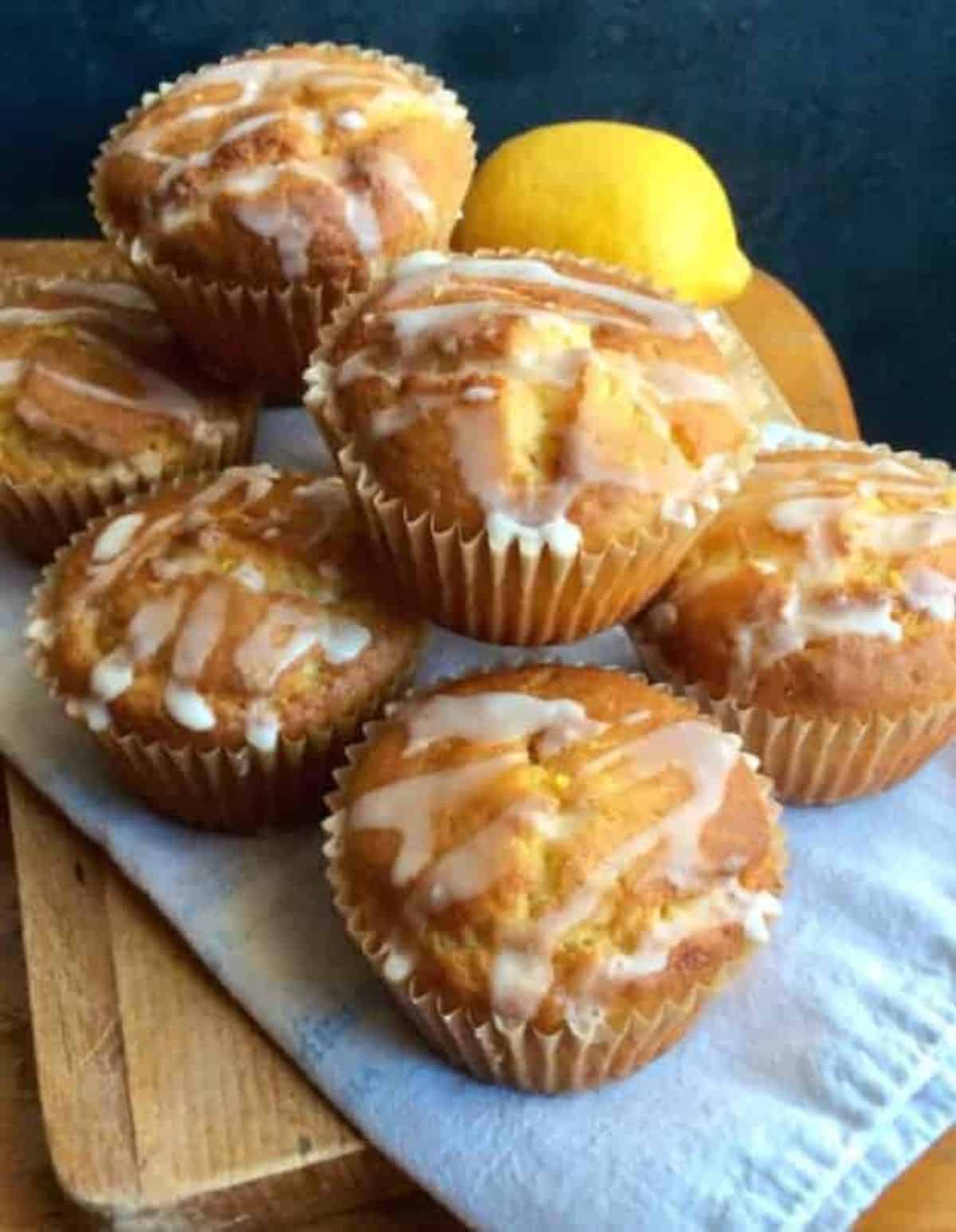 Gluten-free Lemon Yogurt Muffins on a wooden cutting board.