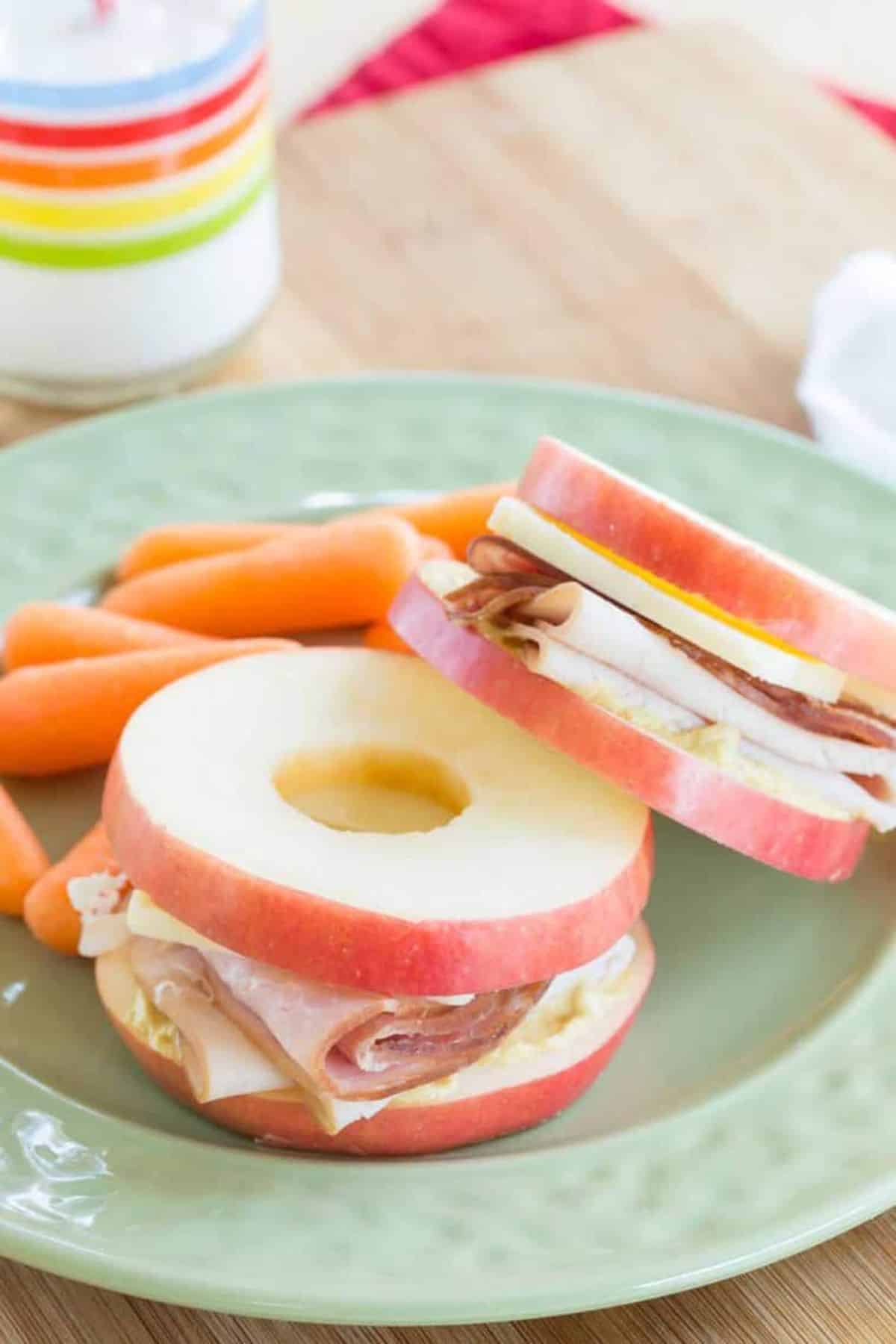 Turkey Ham and Cheese Apple Sandwiches on a green plate.