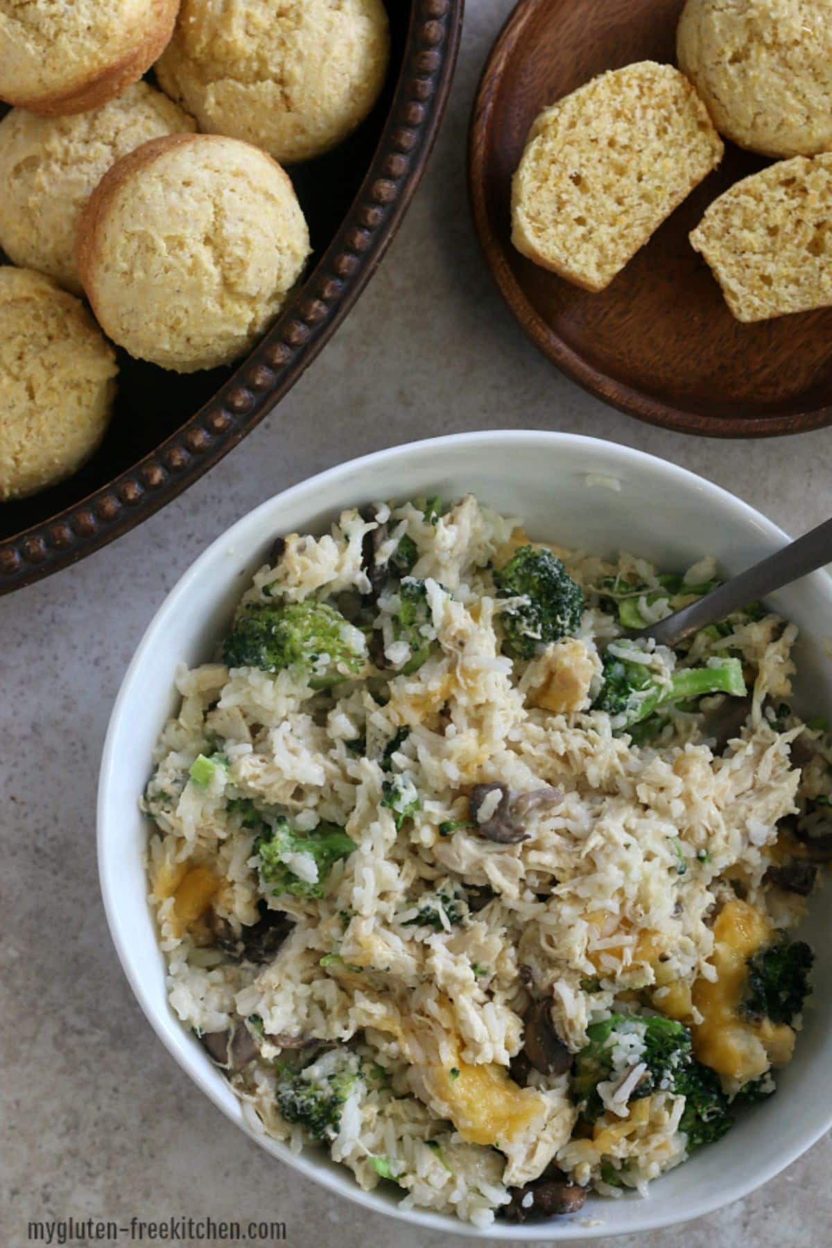Gluten-free Chicken Broccoli Rice in a white bowl with a spoon.