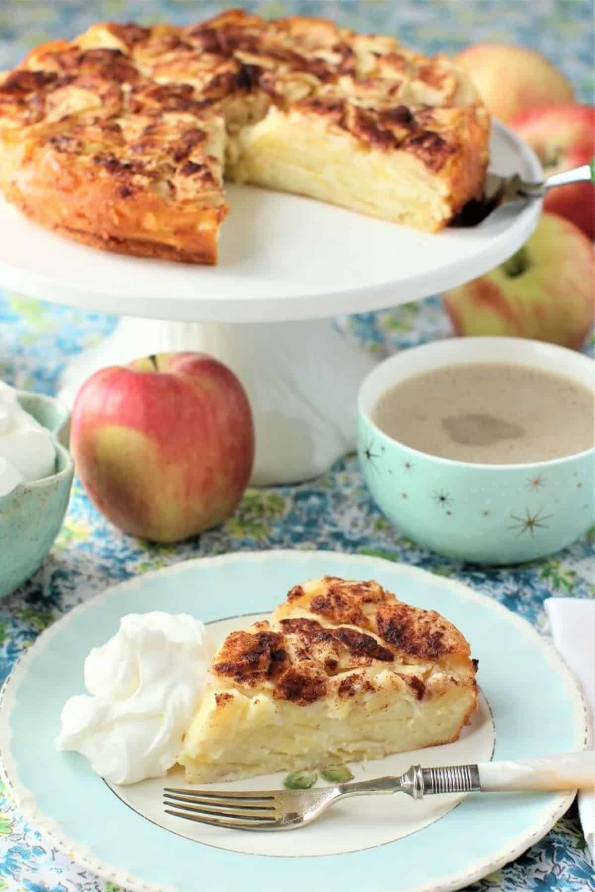 A piece of German Crustless Apple Pie on a blue plate with a fork.