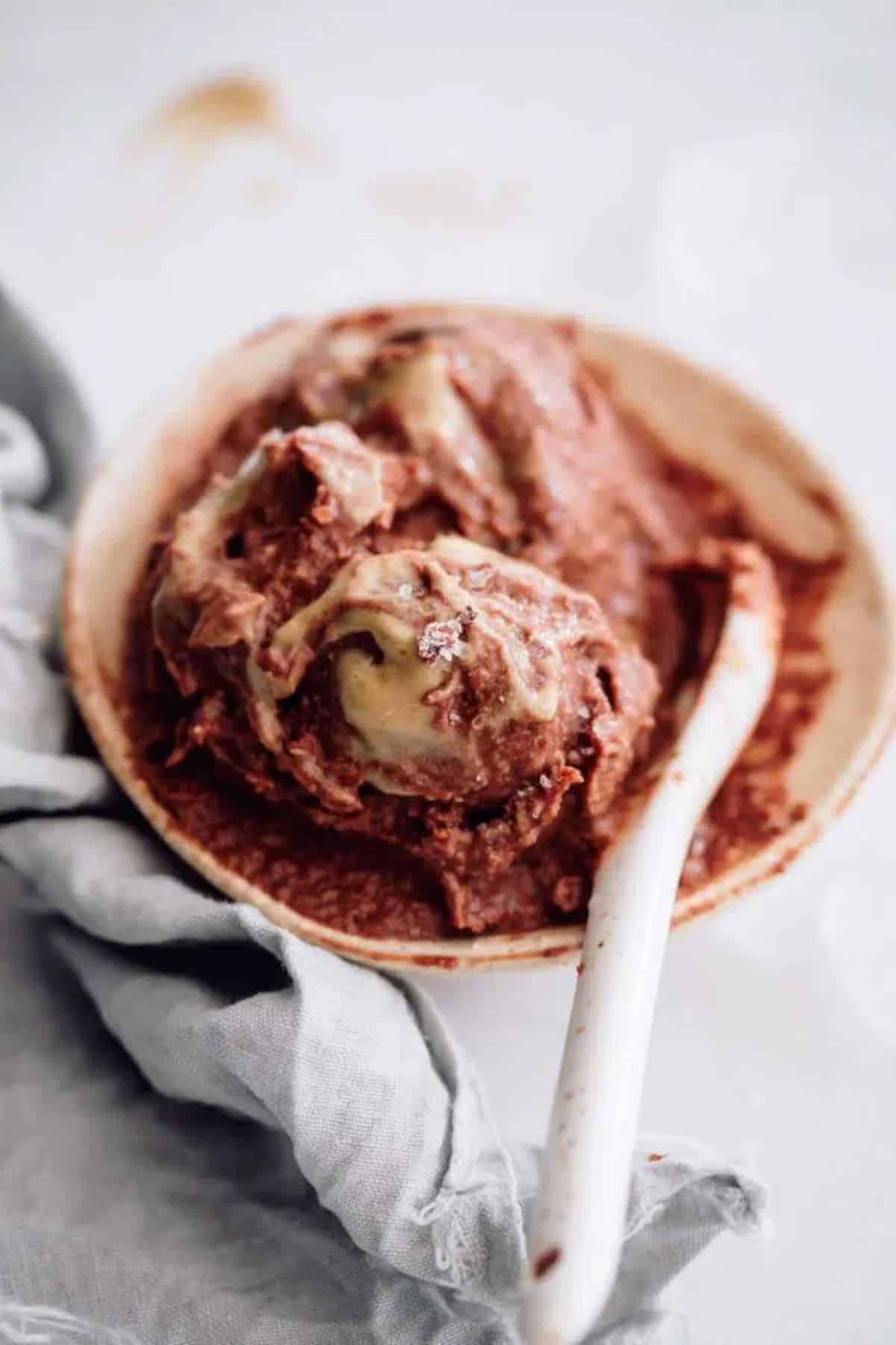A bowl of Chocolate Ice Cream with a spoon.
