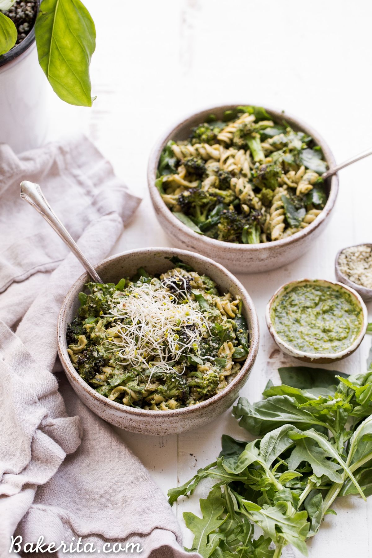 Arugula Pesto Pasta Bowl with Broccoli (Gluten-free & Vegan) in two gray bowls.