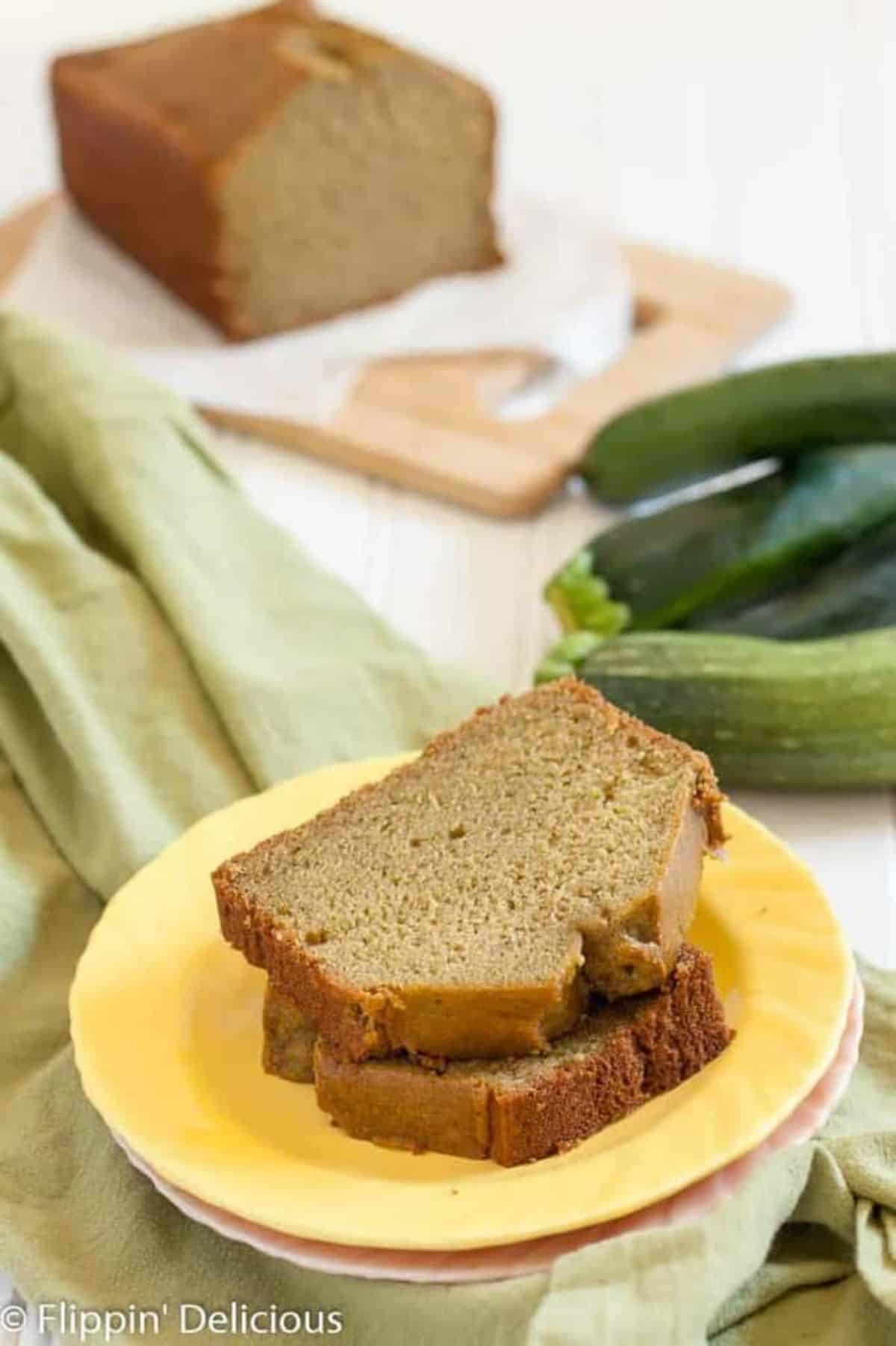 Two slices of Gluten-free Blender Zucchini Bread on a yellow plate.