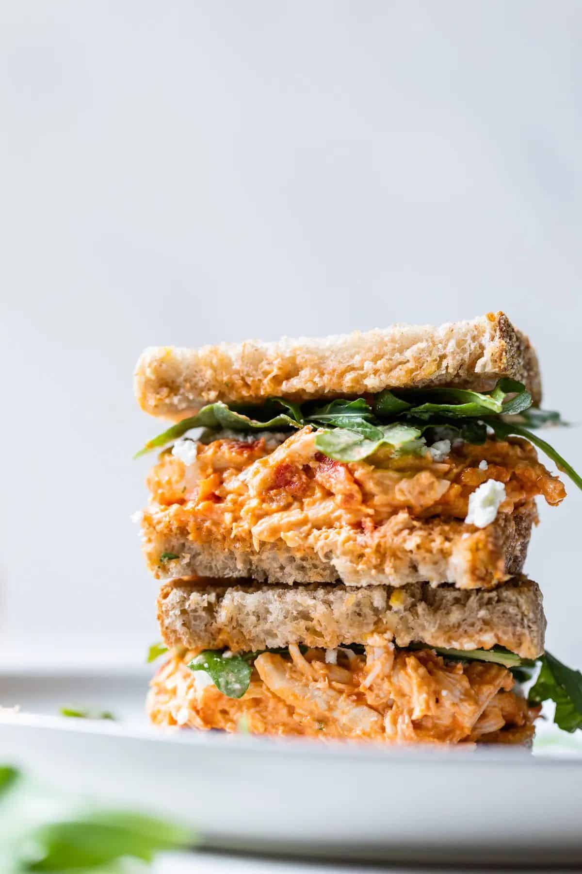 Sun-Dried Tomato Chicken Salad Sandwich on a white plate.