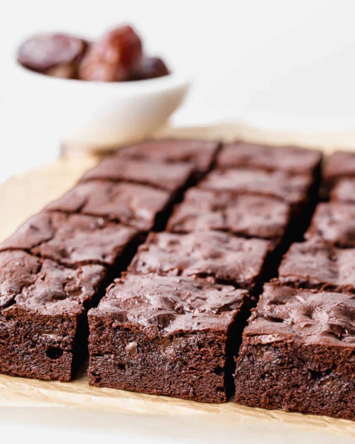 Gluten-Free Chocolate Date Brownies on a wooden tray.