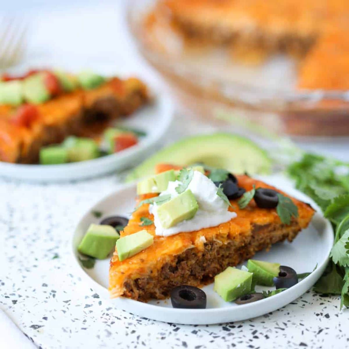 A piece of Crustless Taco Pie on a white tray.