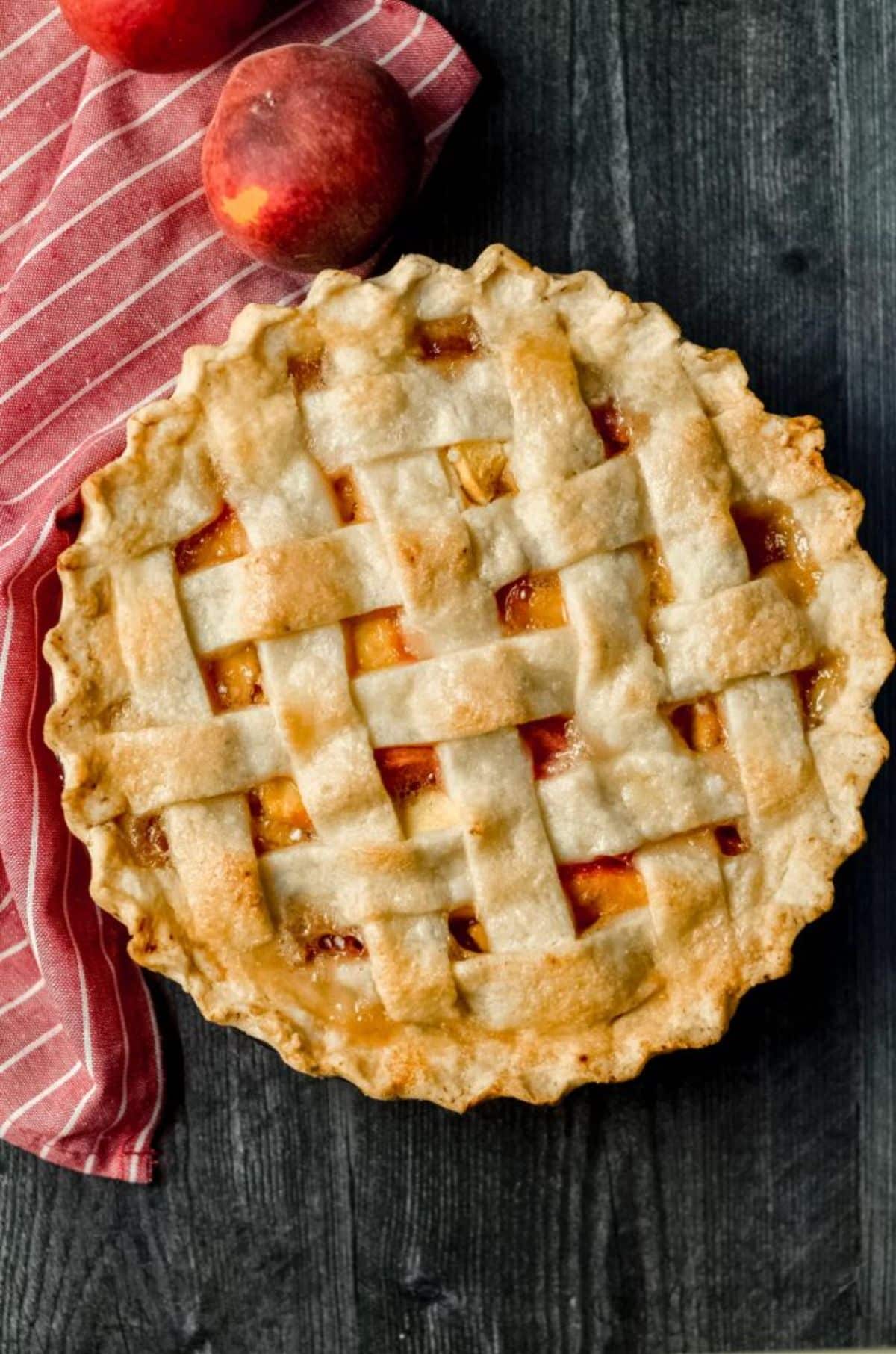 Gluten-Free Peach Pie on a wooden table.