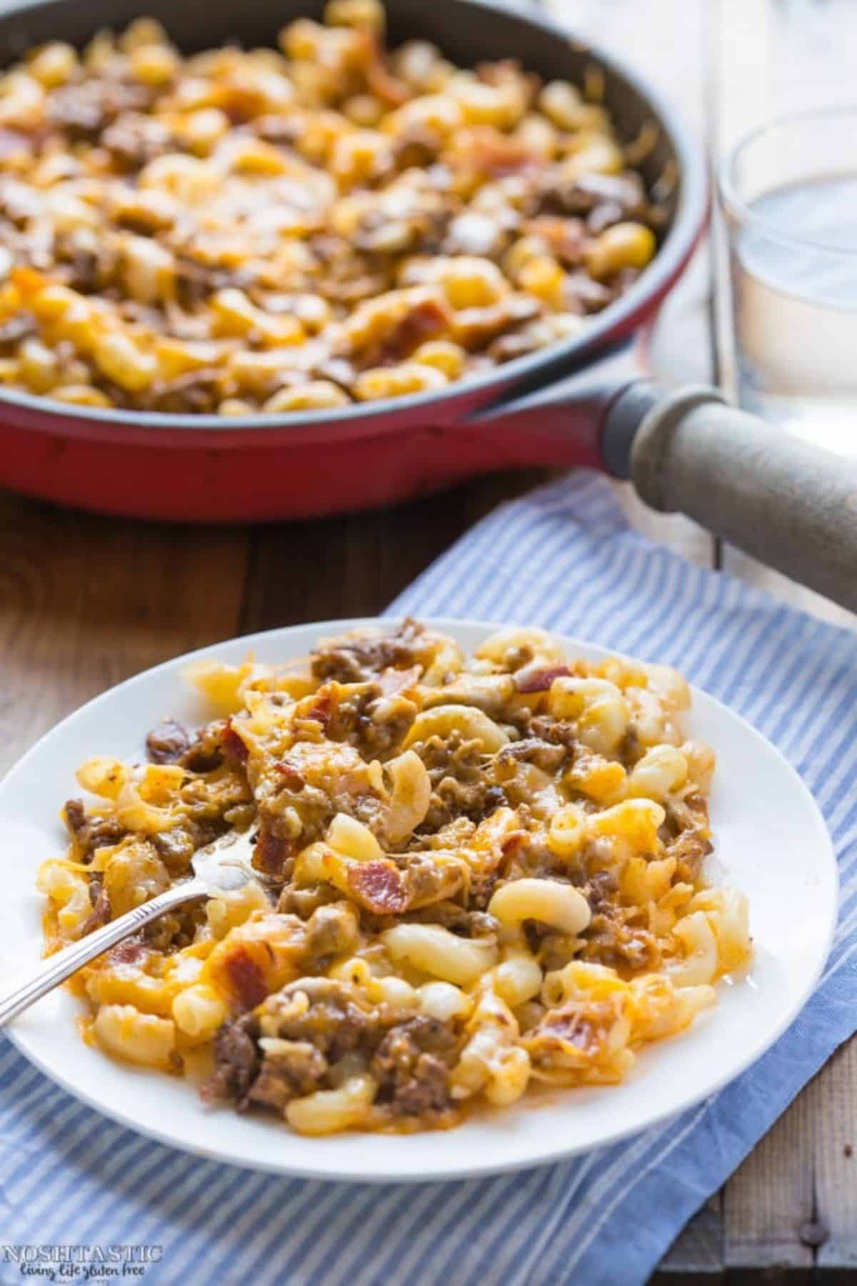 Gluten-Free Bacon Cheeseburger Pasta on a white plate with a fork.