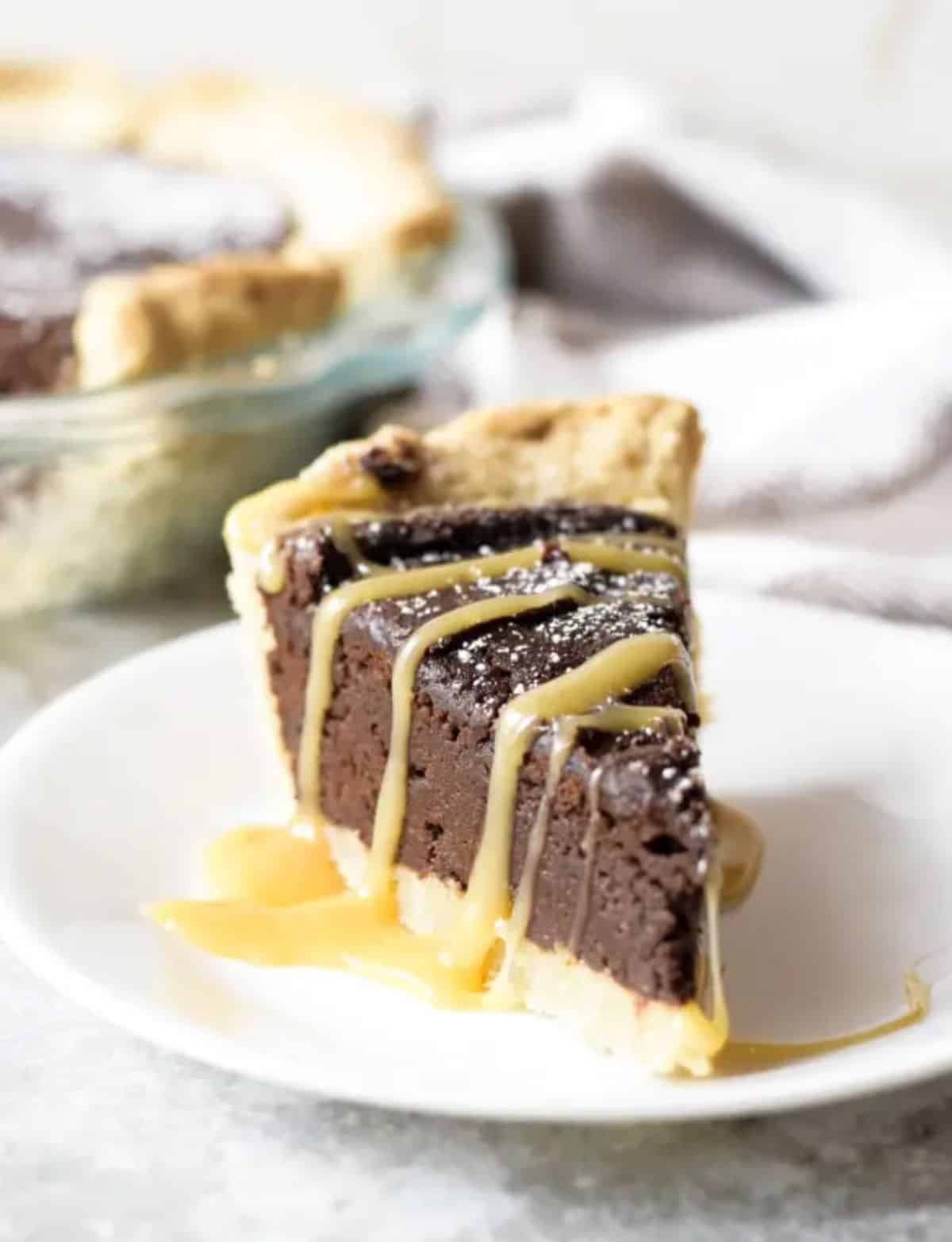 A piece of Fudgy Brownie Pie on a white plate.