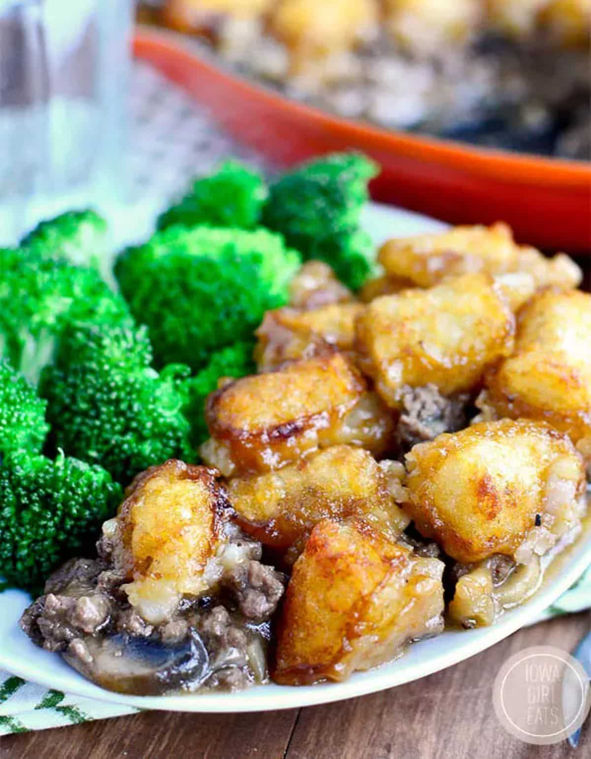Skillet Tater Tot with broccoli on a white plate.