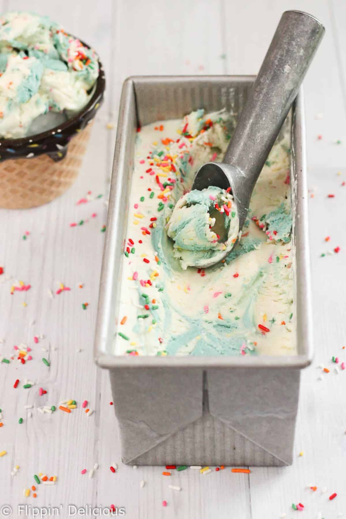 Gluten-free Cake Batter Ice Cream in a container with a spoon.