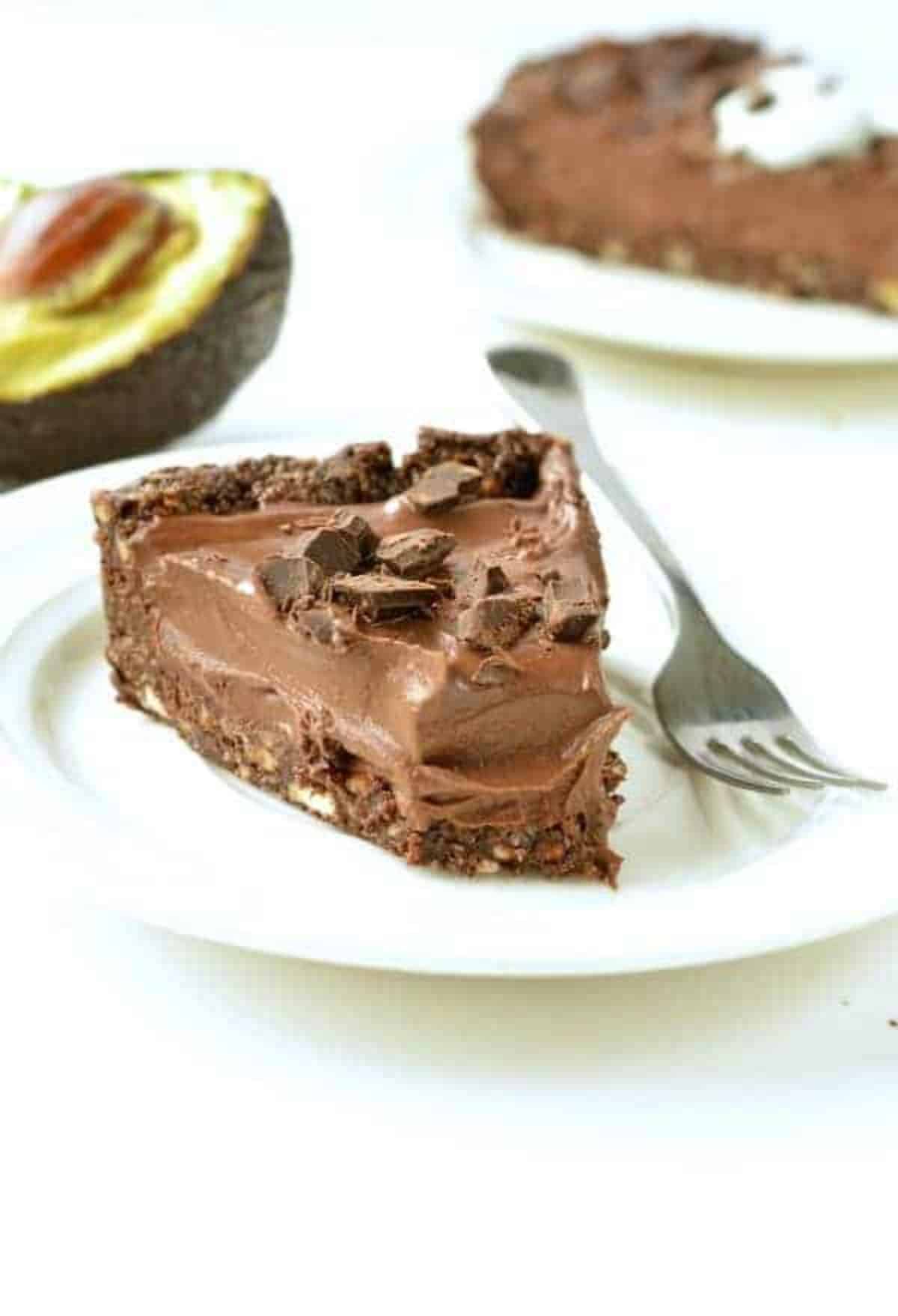 A piece of No Bake Chocolate Avocado Pie on a white plate with a fork.