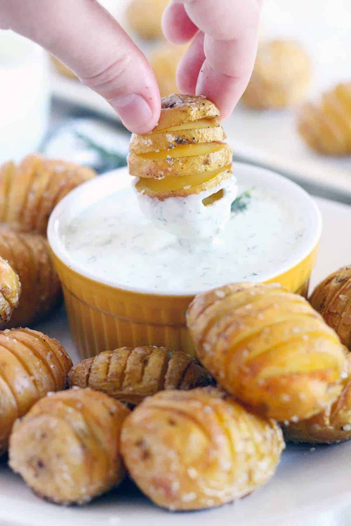 Mini Hasselback Potatoes With Creamy Dill Dip in a small bowl.