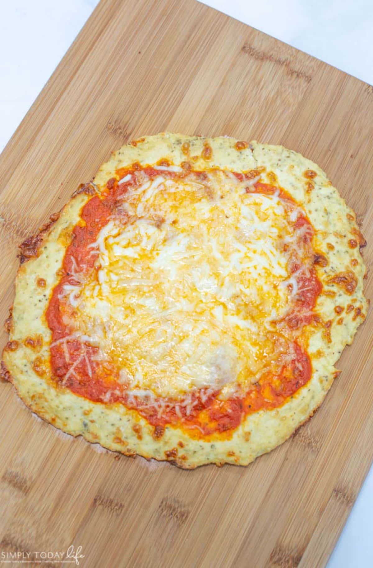 Ground Chicken Pizza Crust on a wooden board.