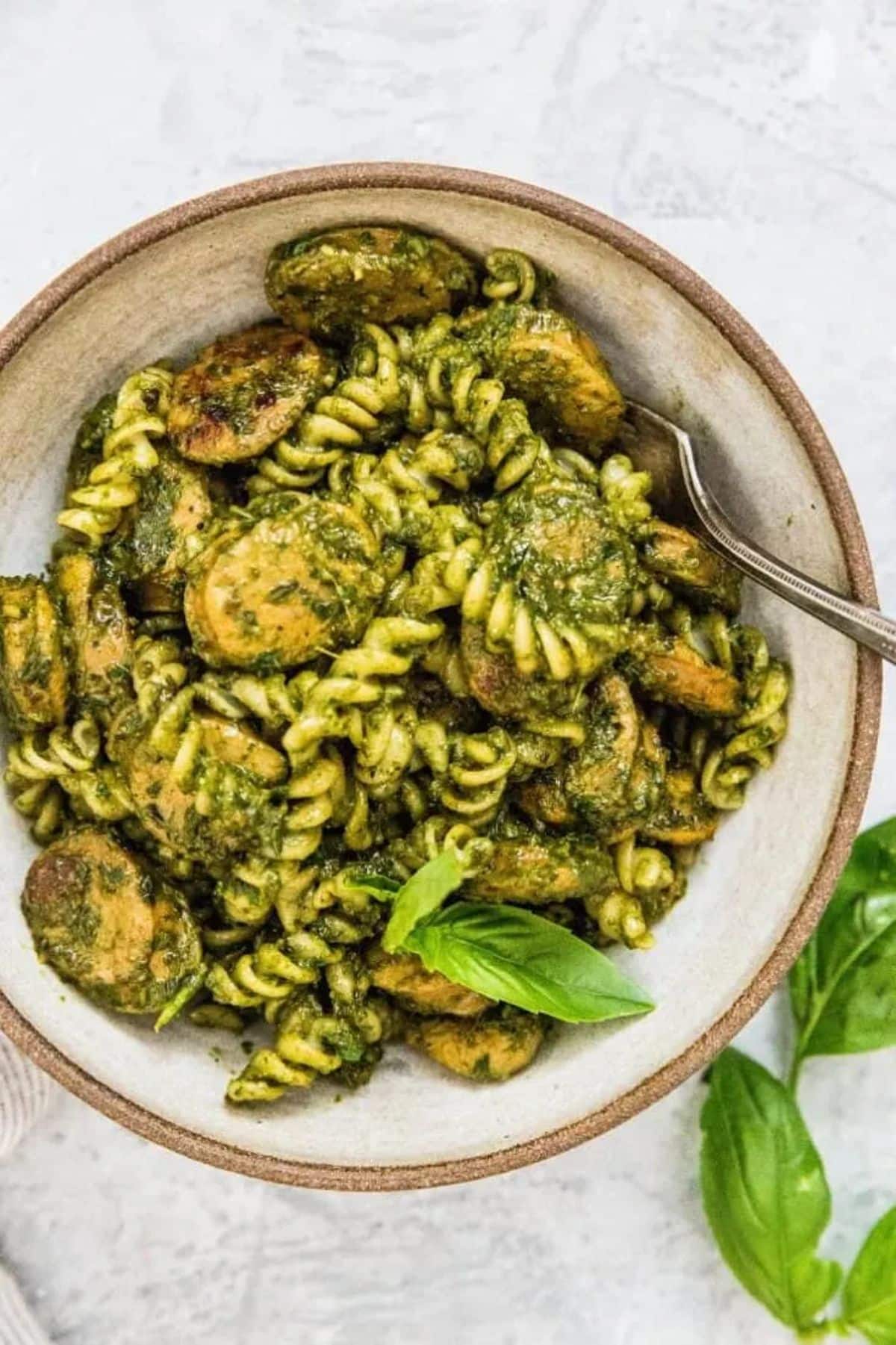 Chicken Sausage Pesto Pasta in a bowl with a fork.