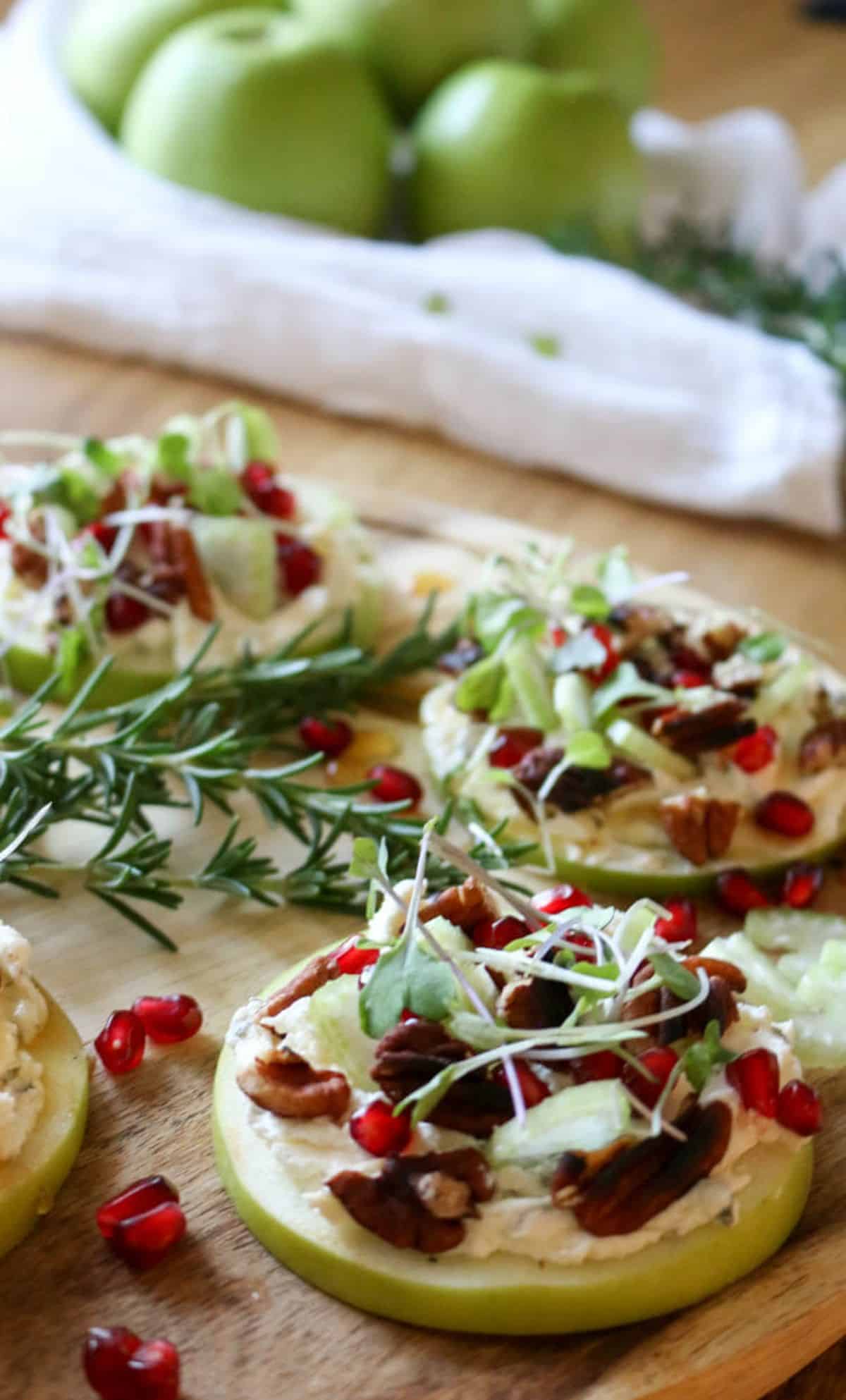 Savory Sliced Apple Appetizers on a wooden cutting board.