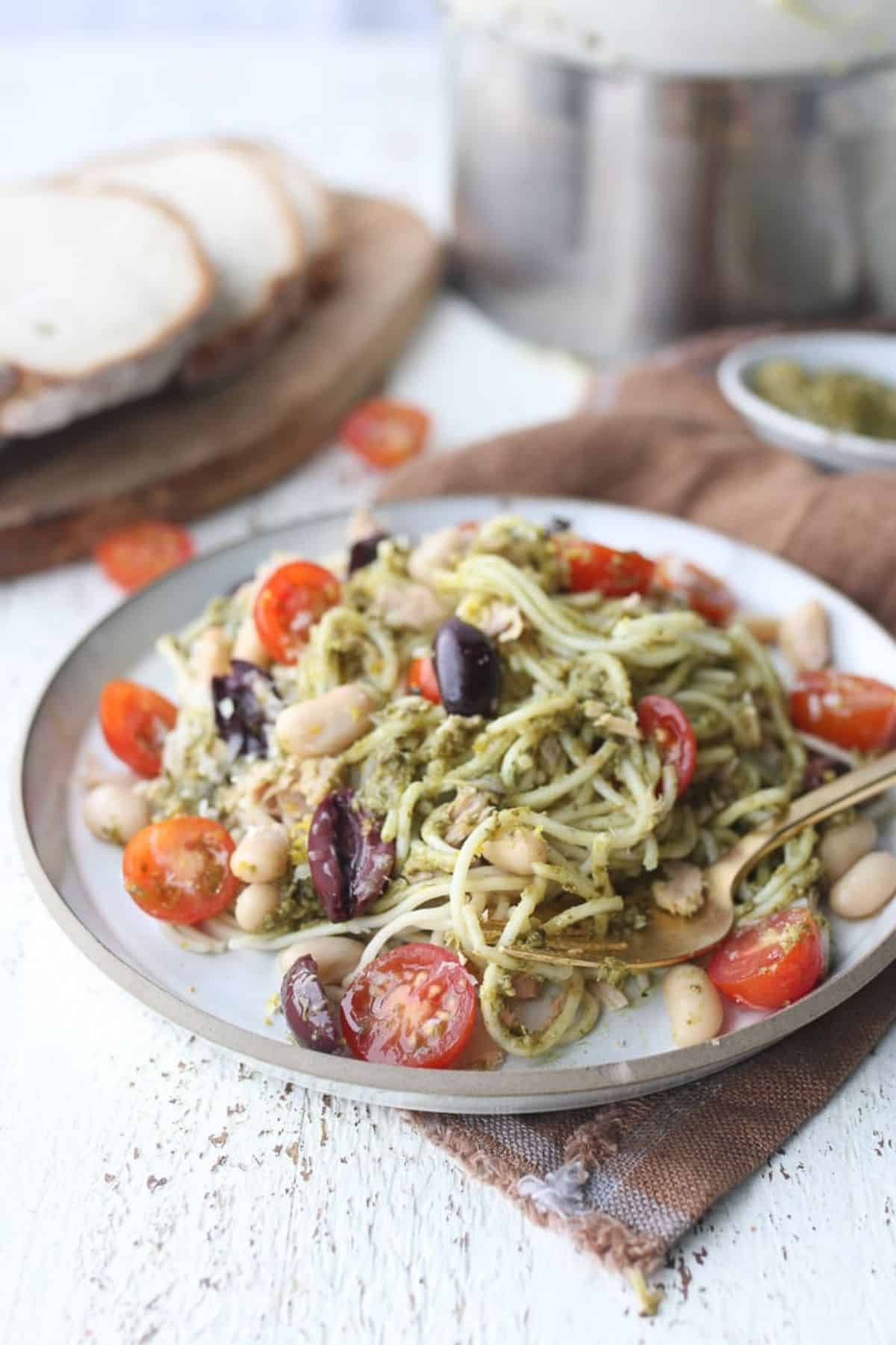 Tuna Pesto Pasta on a gray plate with a fork.