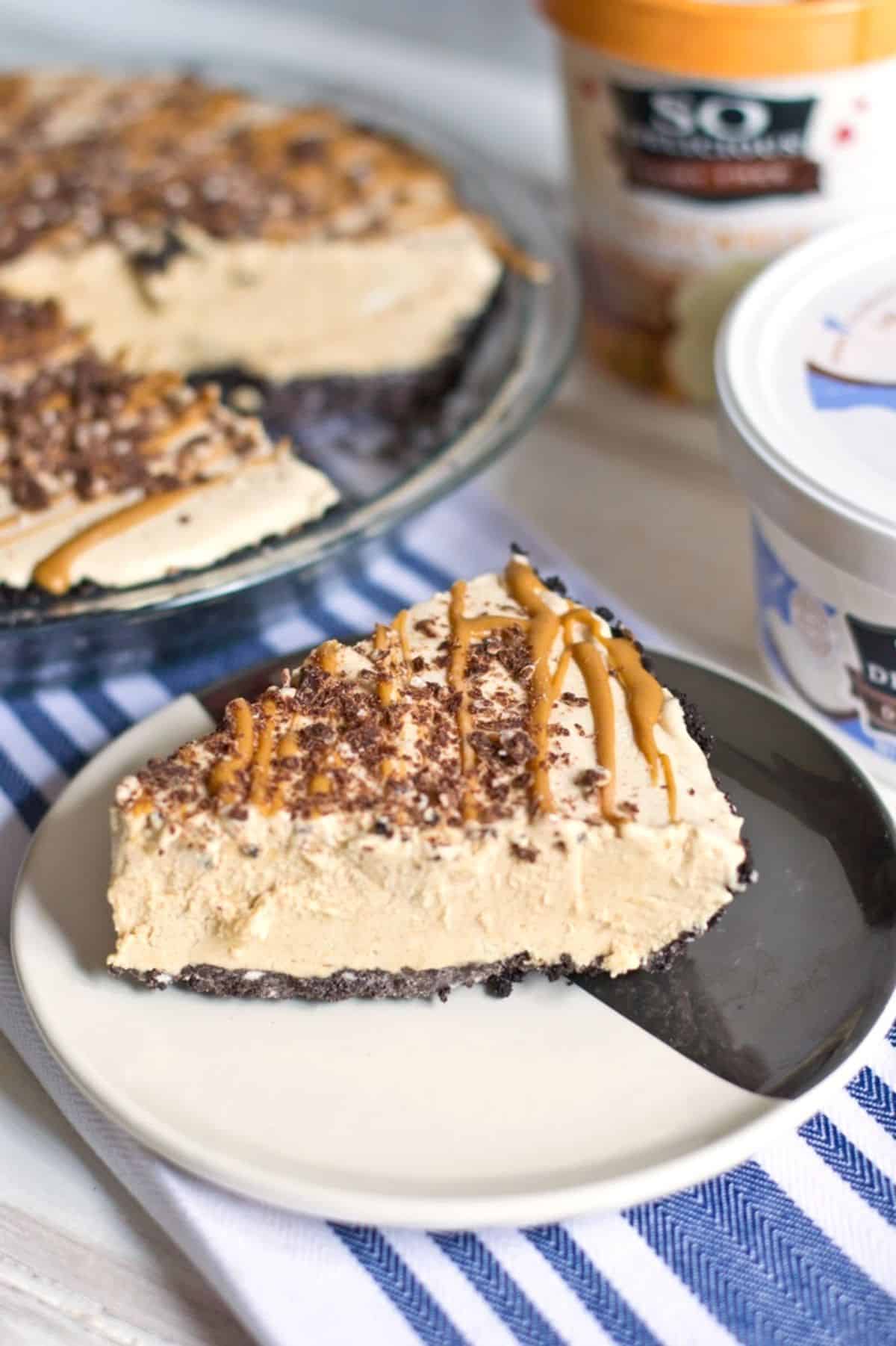 A piece of Dairy-Free Peanut Butter Ice Cream Pie with Chocolate Cookie Crust on a black and white plate.