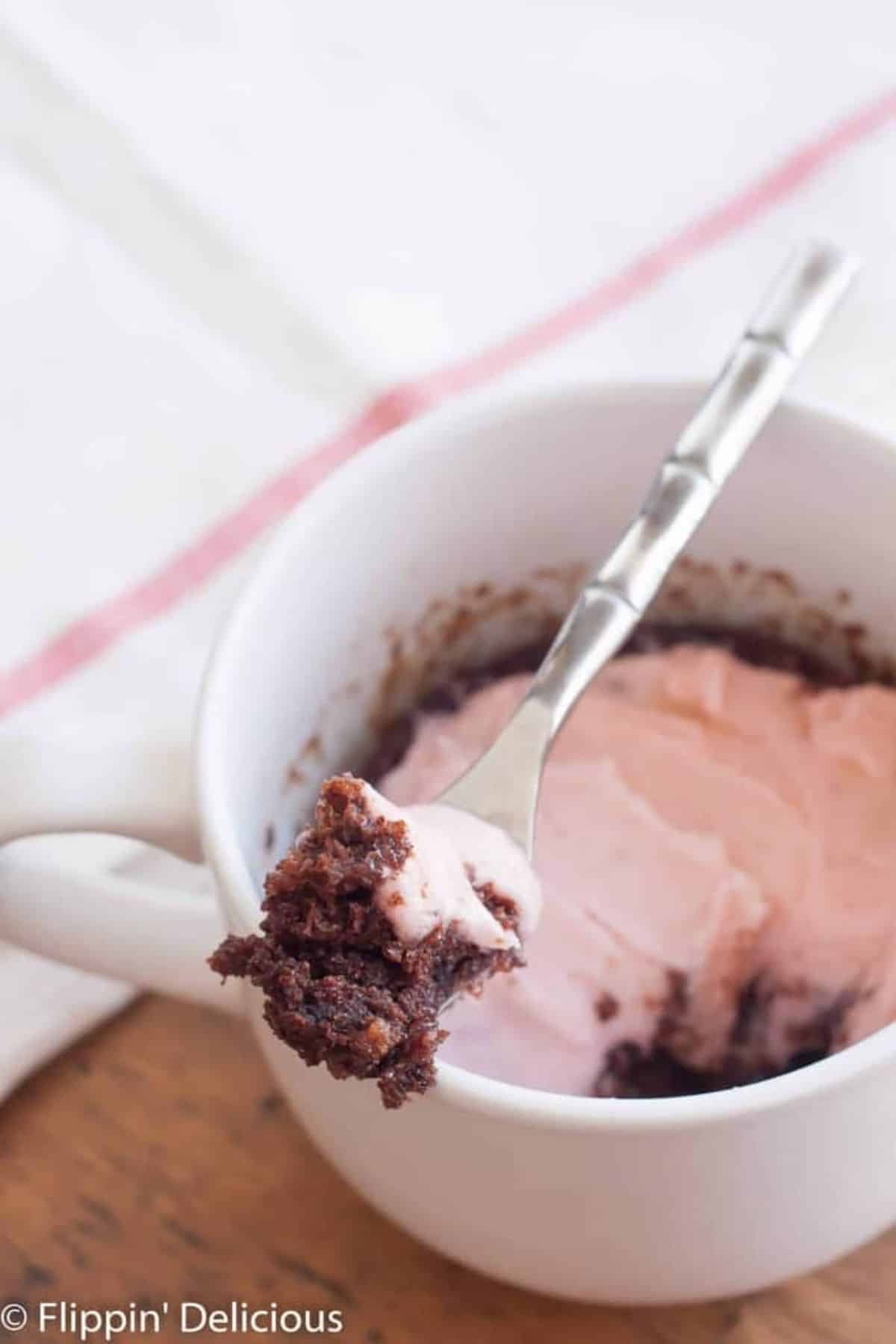 Gluten-Free Chocolate Mug Cake in a cup with a spoon.