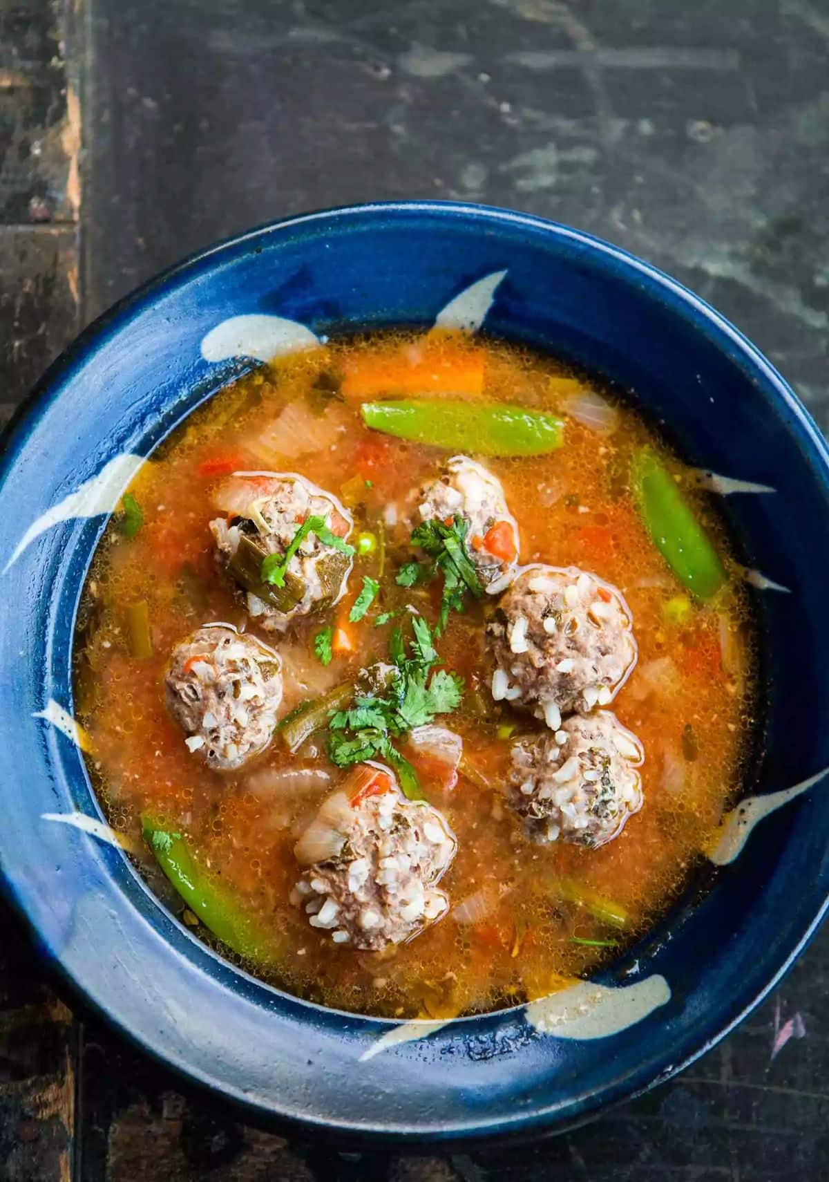 Albondigas Soup (Mexican Meatball Soup) on a blue plate.