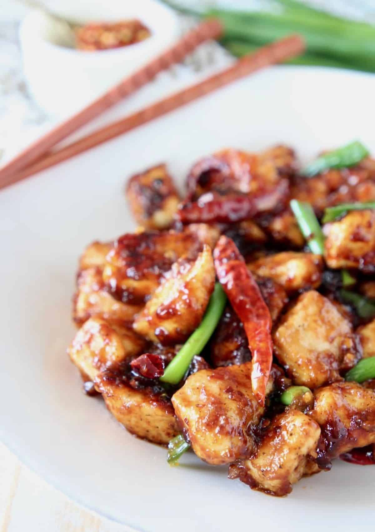 Gluten-Free General Tso’s Chicken on a white plate with chopsticks.