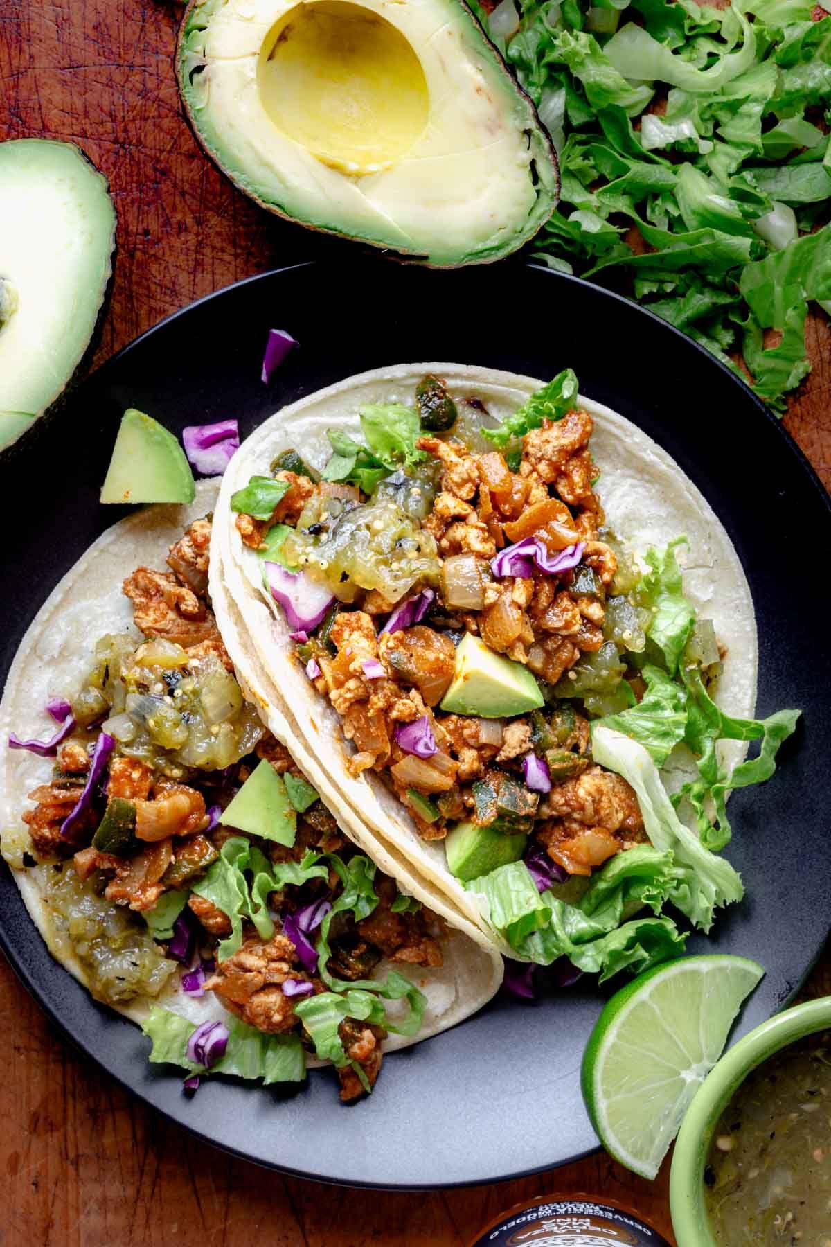 Chicken Tacos with Poblanos on a black plate.