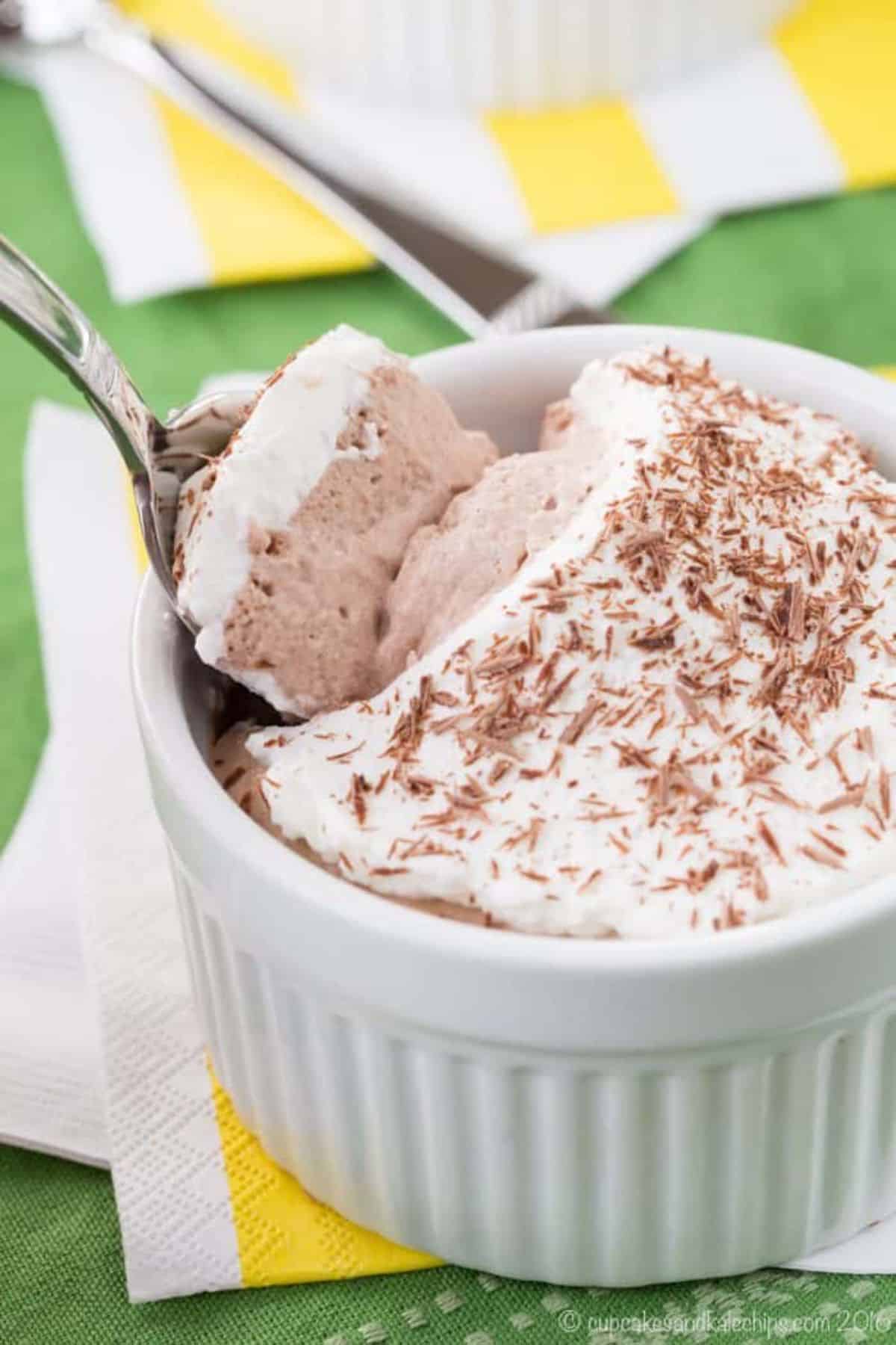No Bake Mini Irish Cream Chocolate Mousse Pie in a white bowl scooped by a spoon.