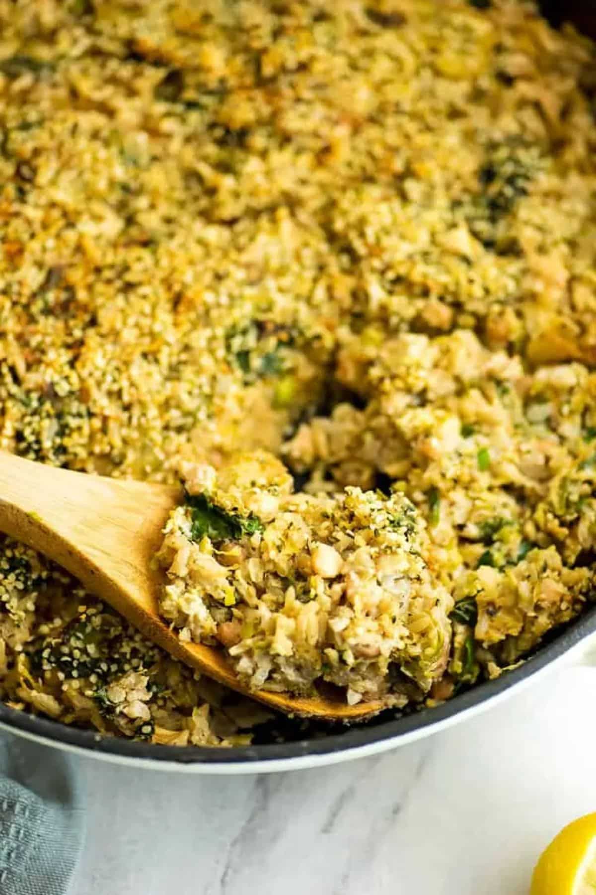 Vegan Brussel Sprout in a casserole with a wooden spoon.