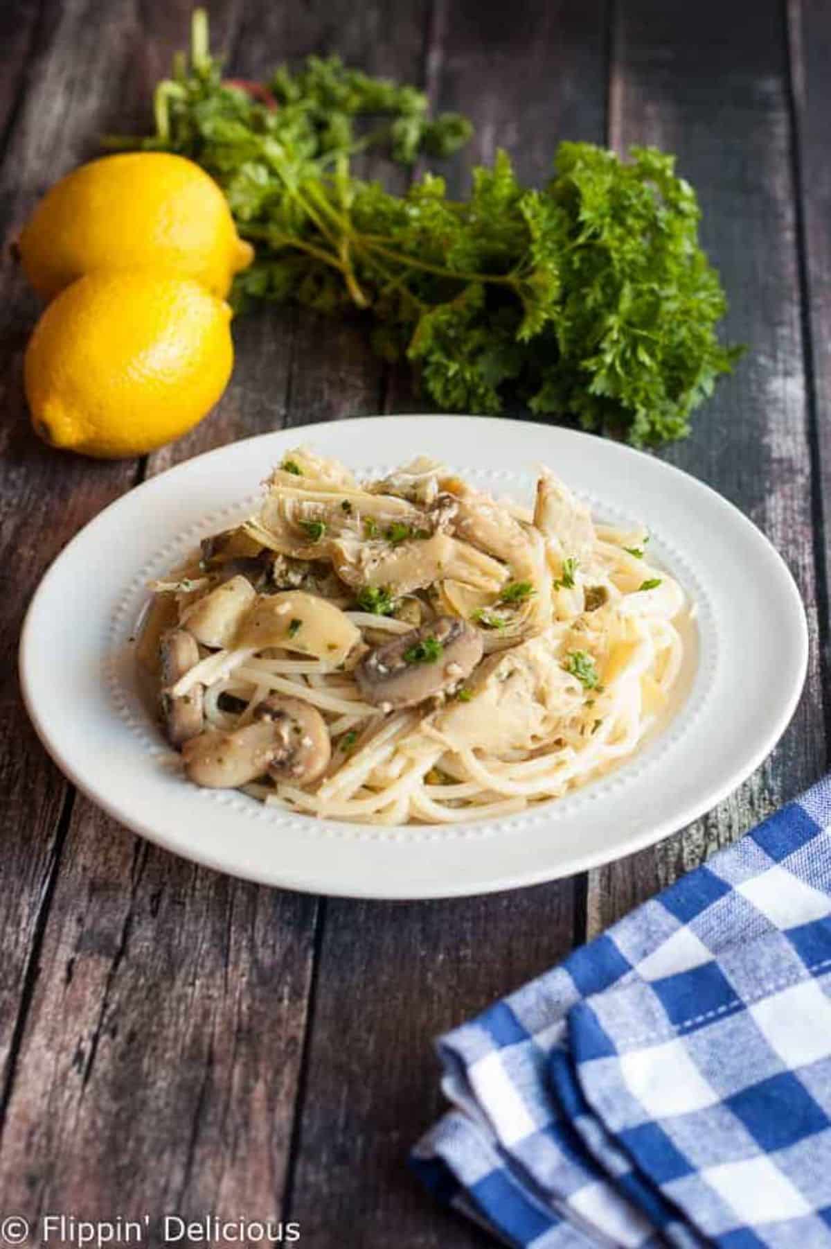 Gluten-free Pasta with White Wine Sauce on a white plate.