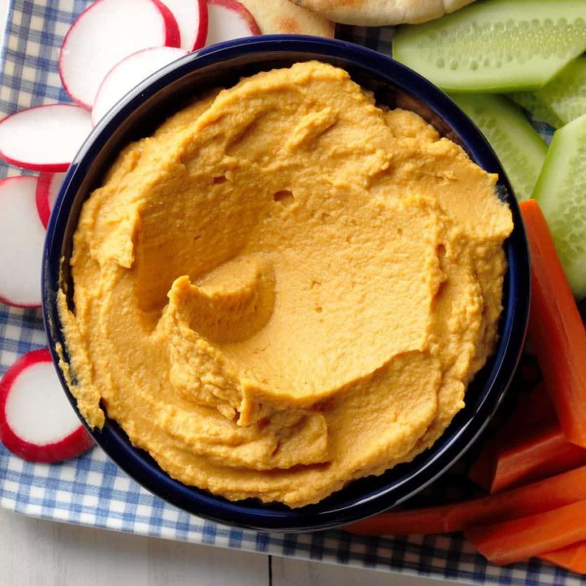 Pumpkin Hummus in a dark bowl.