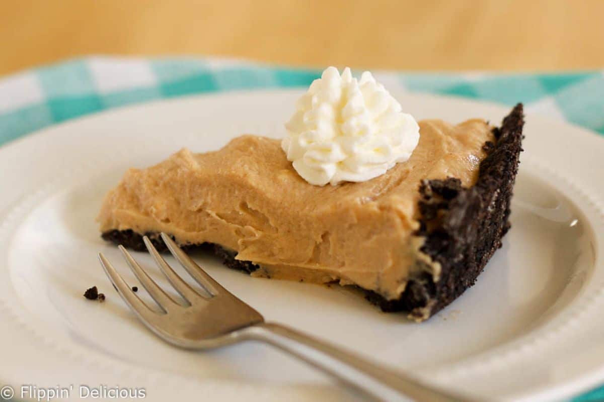 A piece of Gluten-Free Peanut Butter Pie on a white plate with a fork.