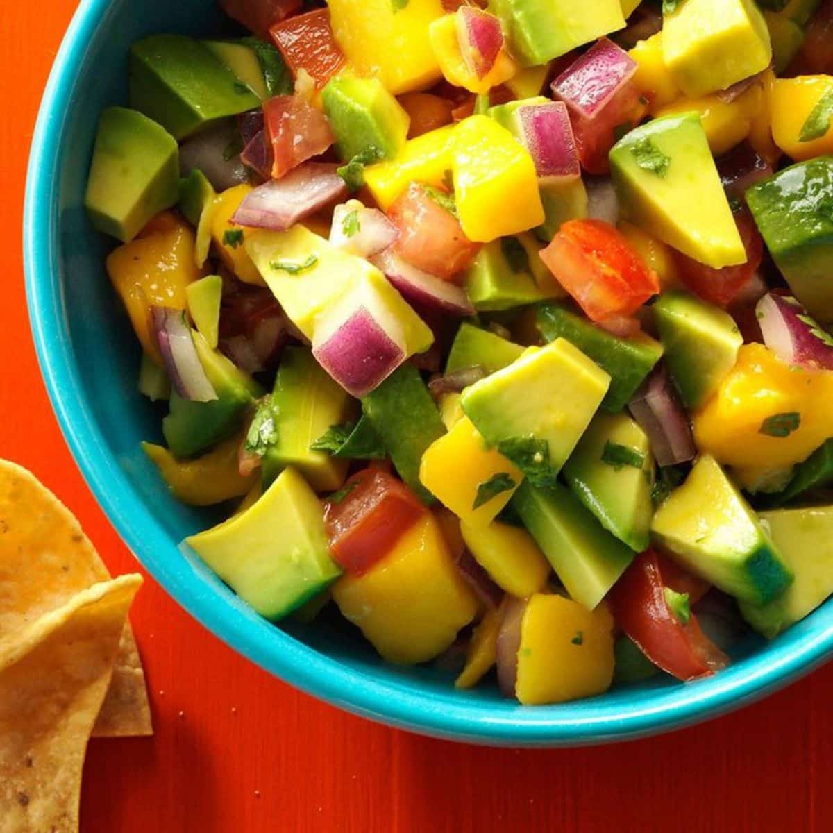 Chunky Mango Guacamole dip in a blue bowl.