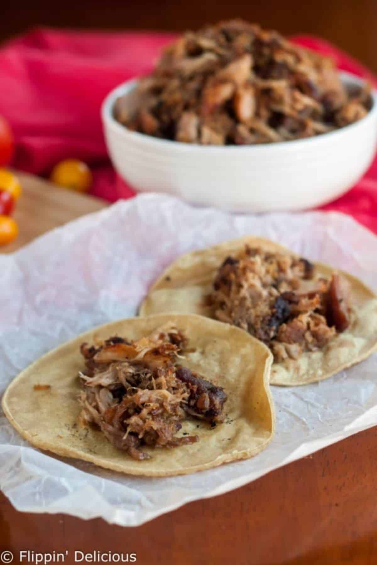 Easy Gluten-Free Slow Cooker Crispy Carnitas on two corn torillas.