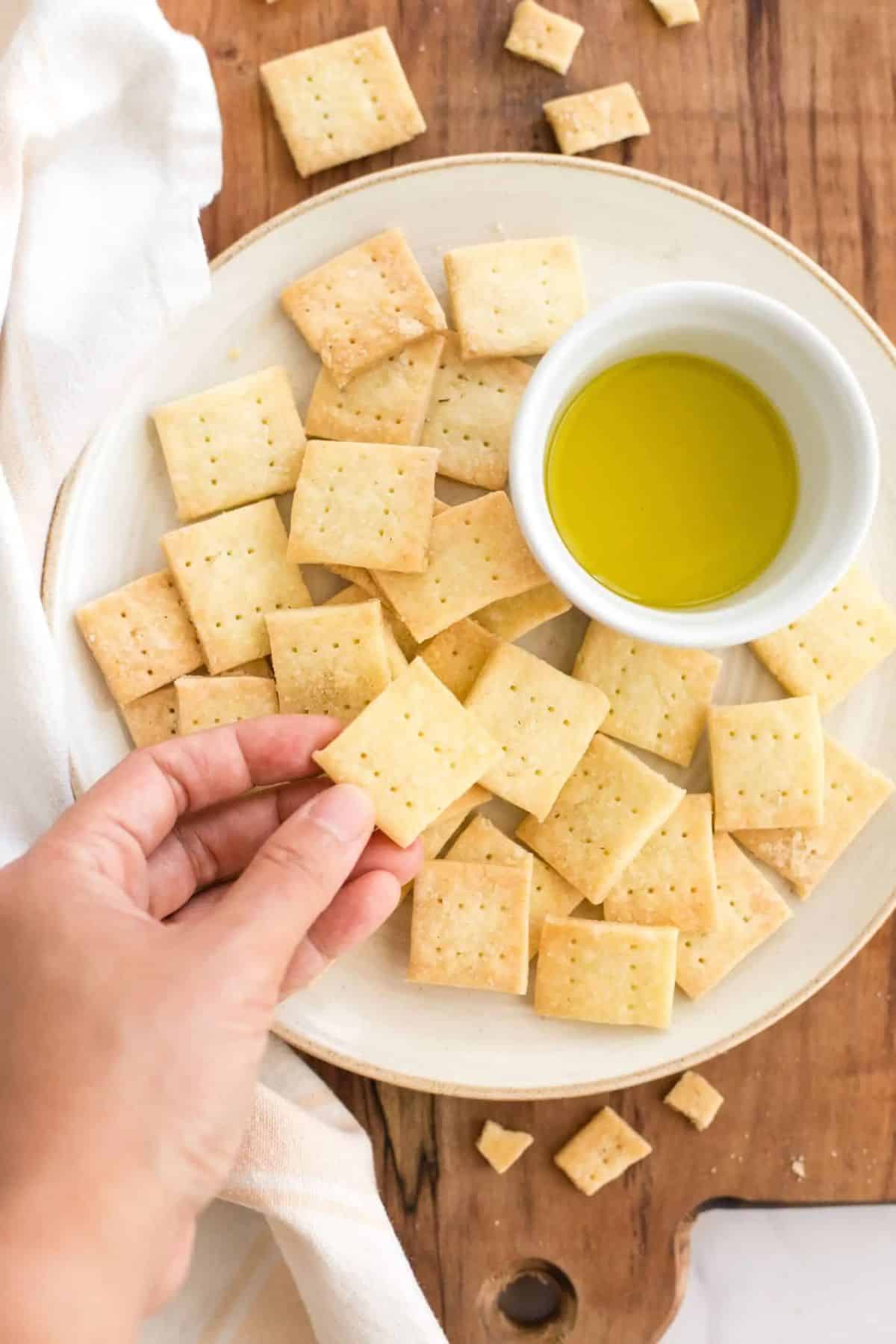 Gluten-Free Crackers on a white plate picked by hand.