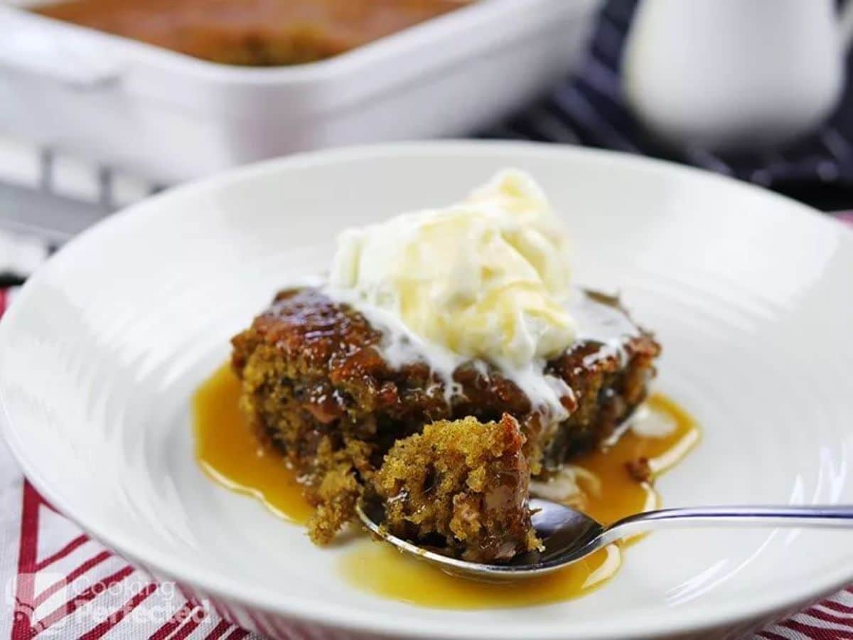 Gluten-Free Sticky Date Pudding on a white plate with a spoon.