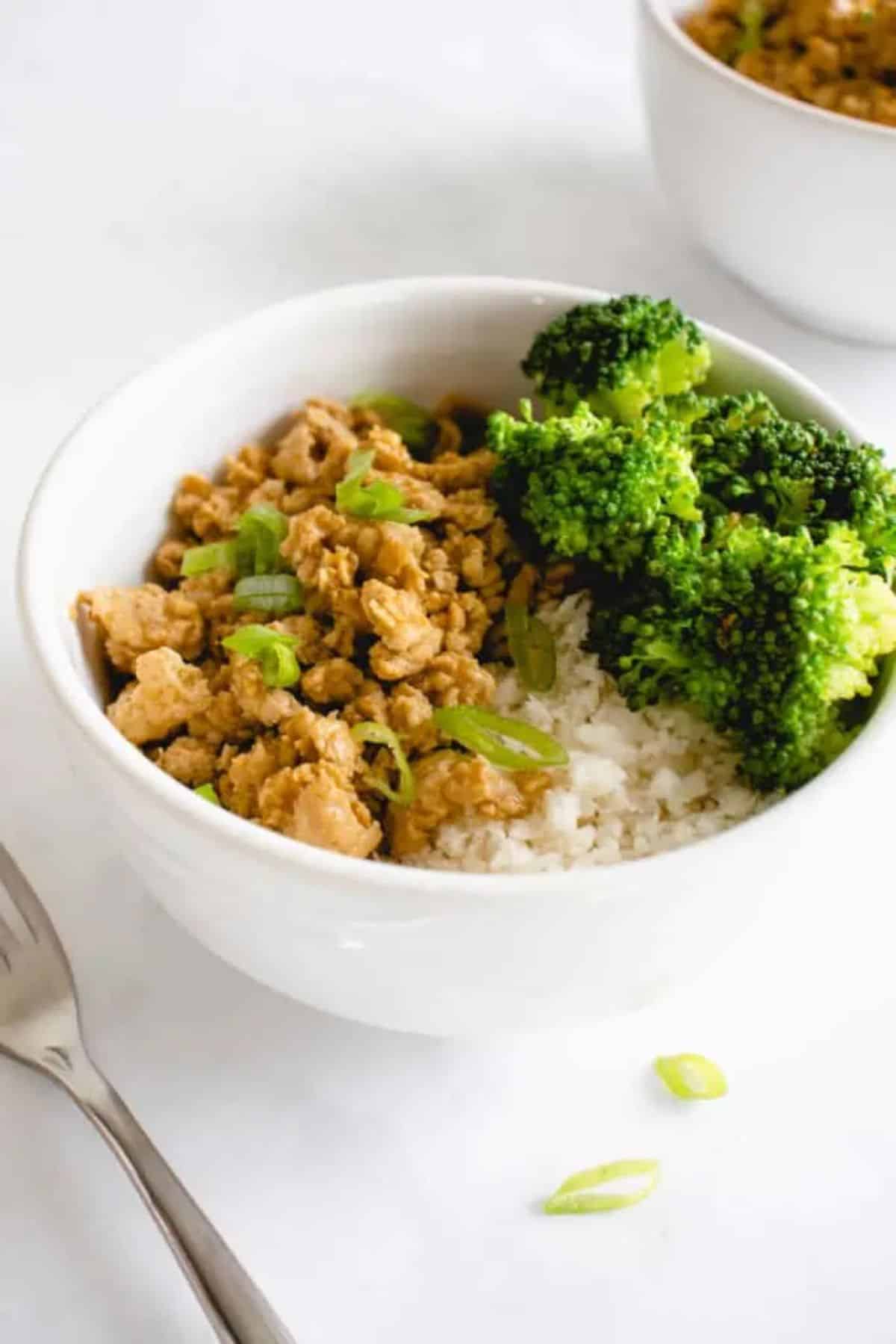 Gluten-Free Orange Chicken with broccoli and rice in a white bowl.
