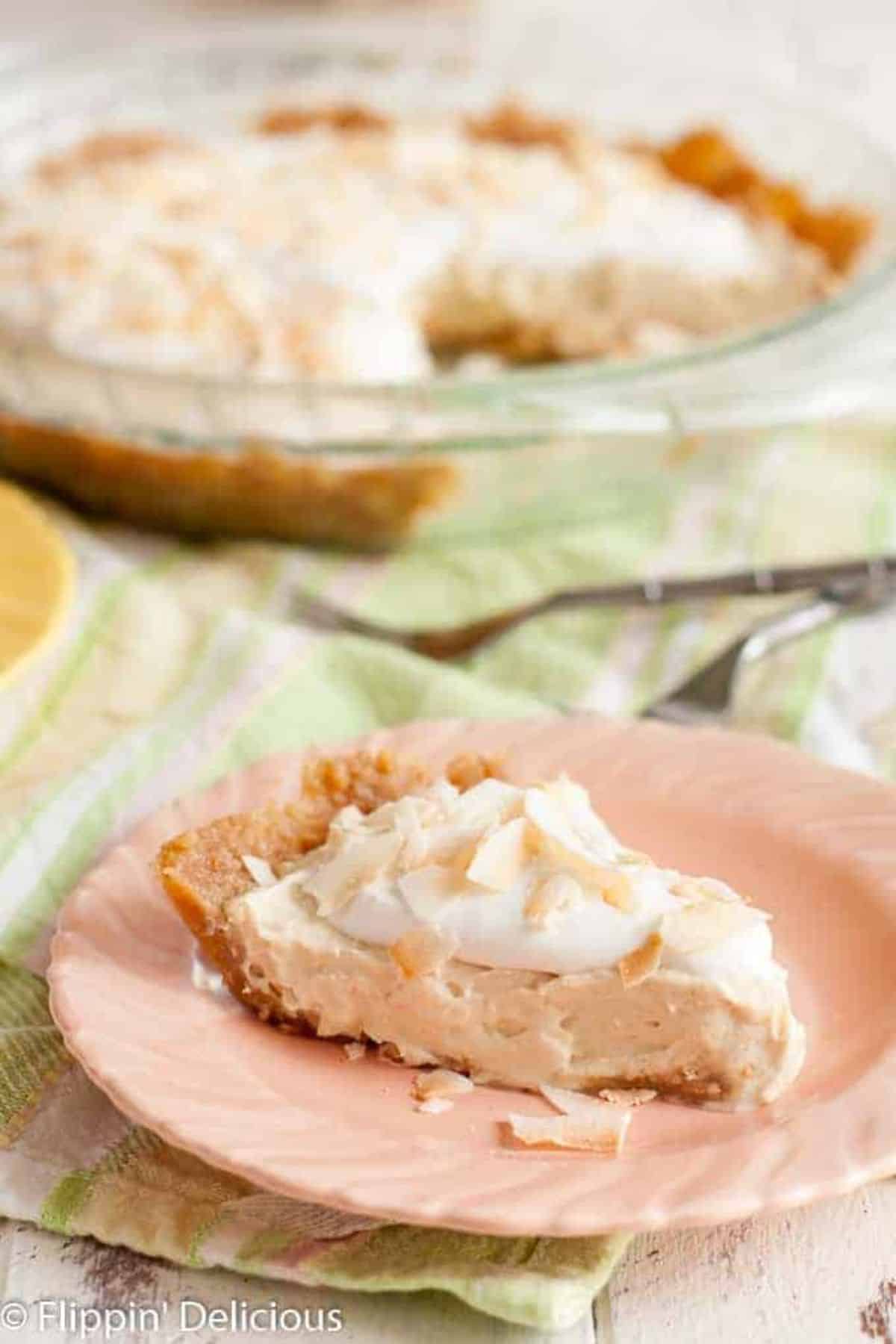 A piece of Gluten-Free Dairy-Free Coconut Cream Pie on a pink plate.