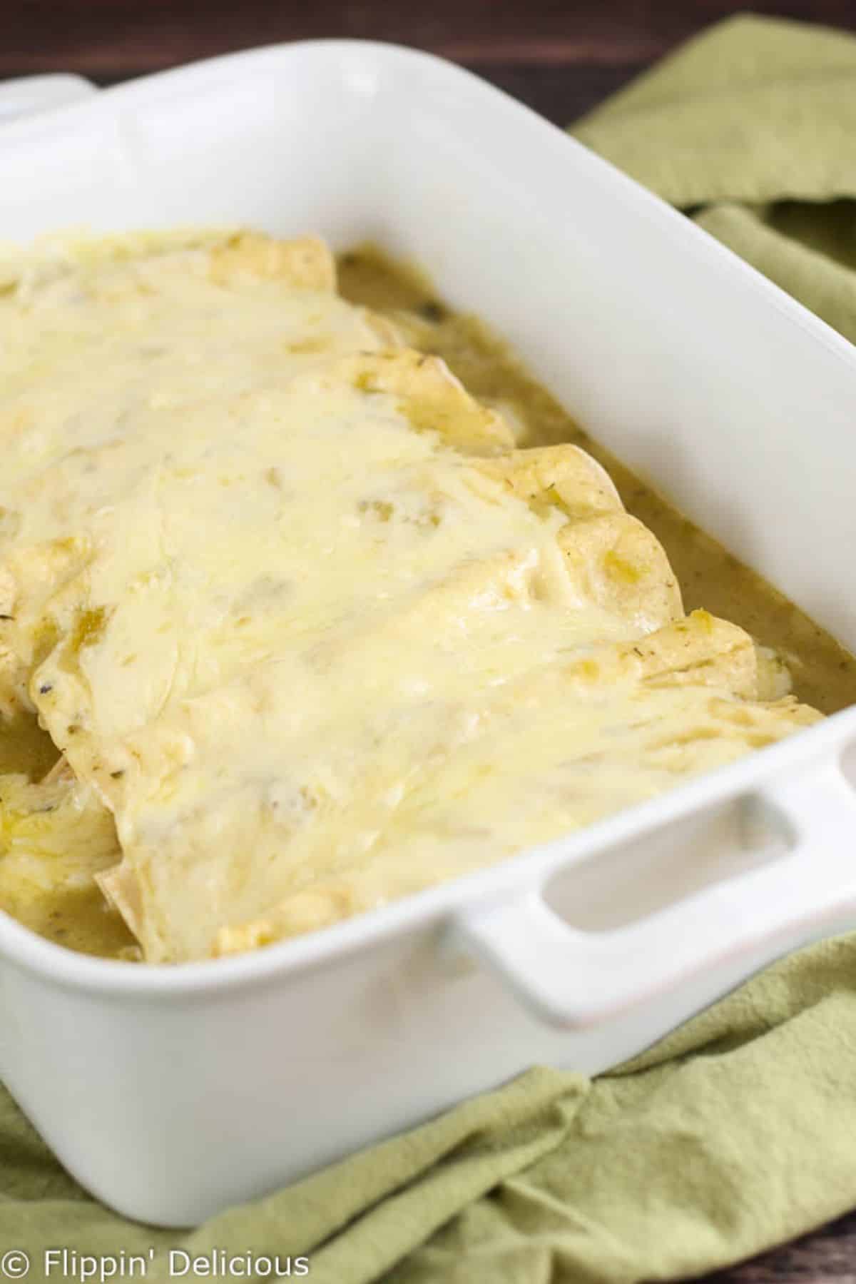 Gluten-Free Green Chile Enchiladas in a white casserole.