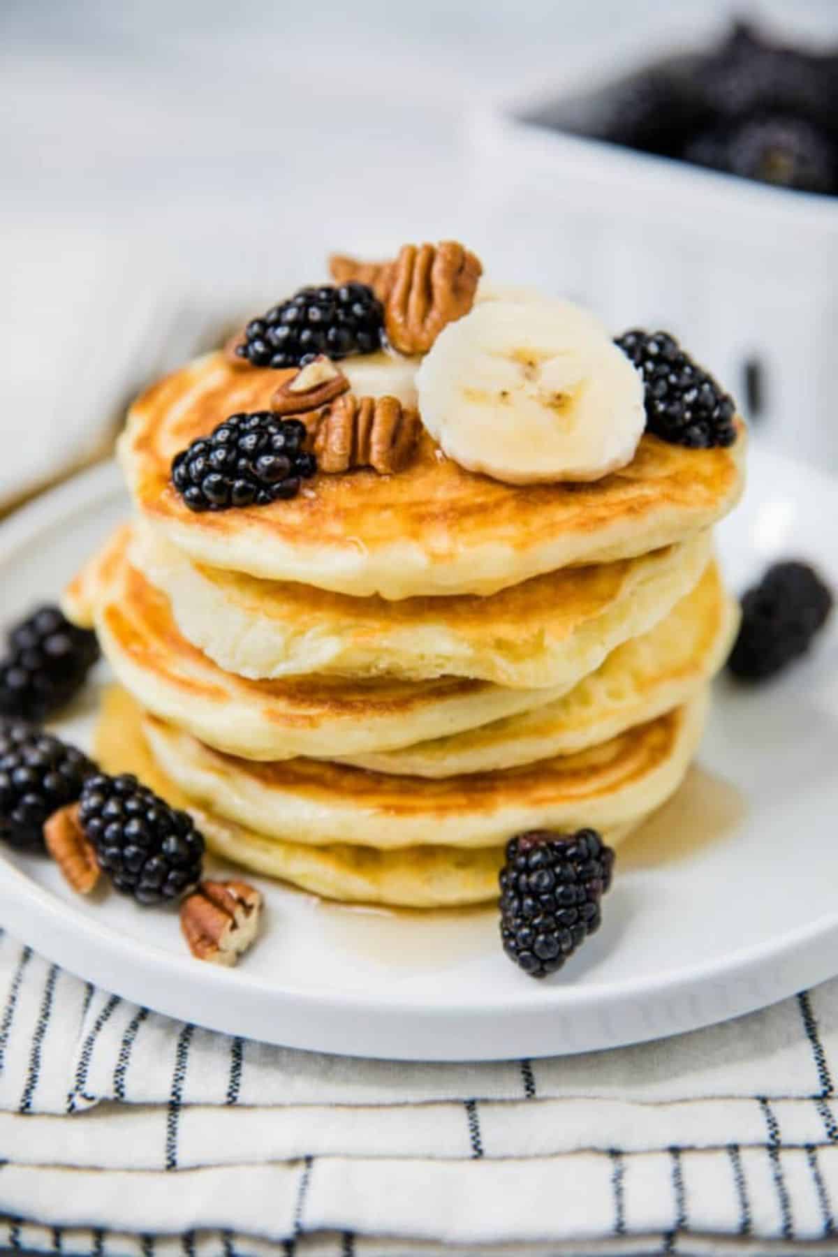 A pile of Fluffy Gluten-free Yogurt Pancakes on a white tray.