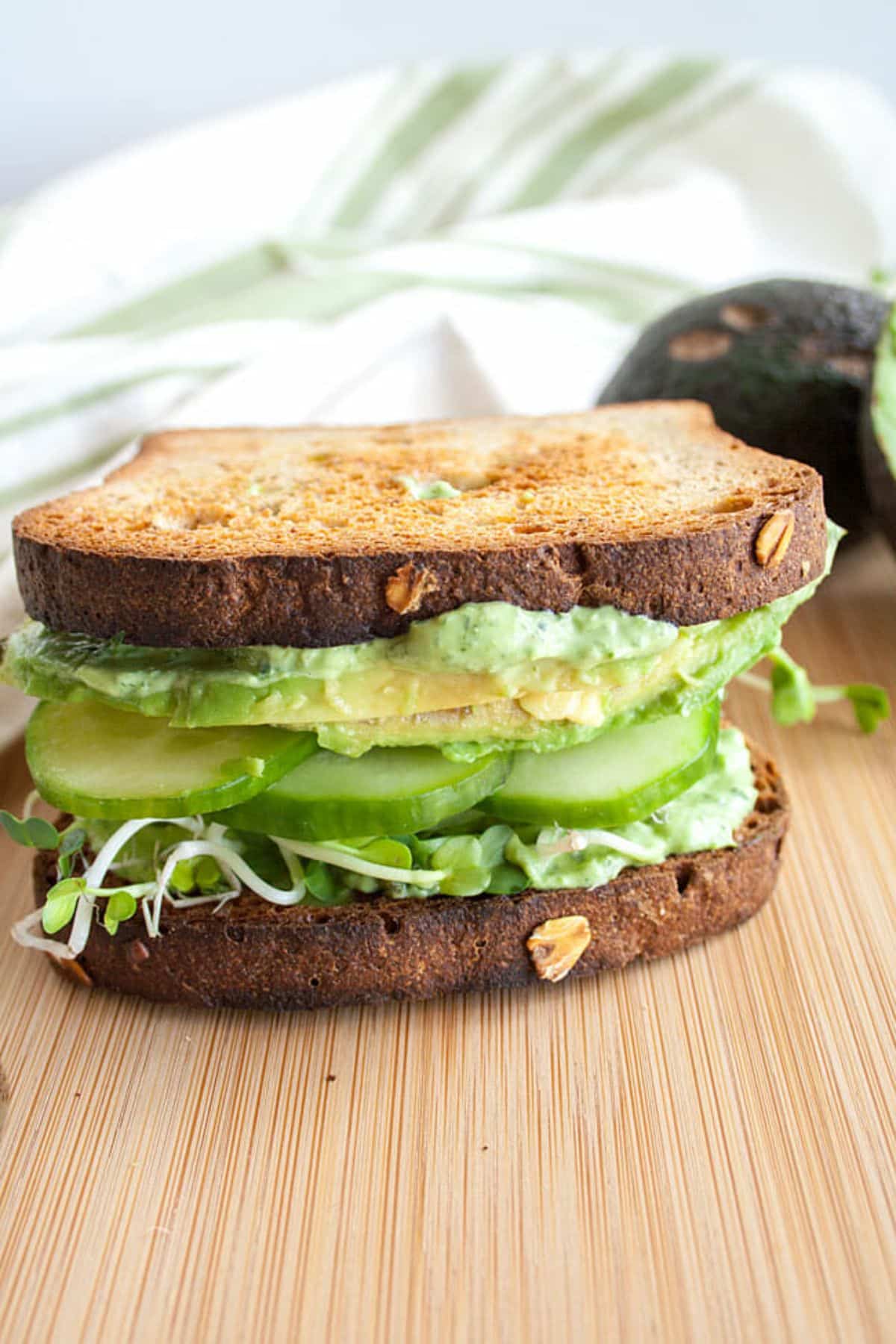 Green Goddess Sandwich on a wooden cutting board.