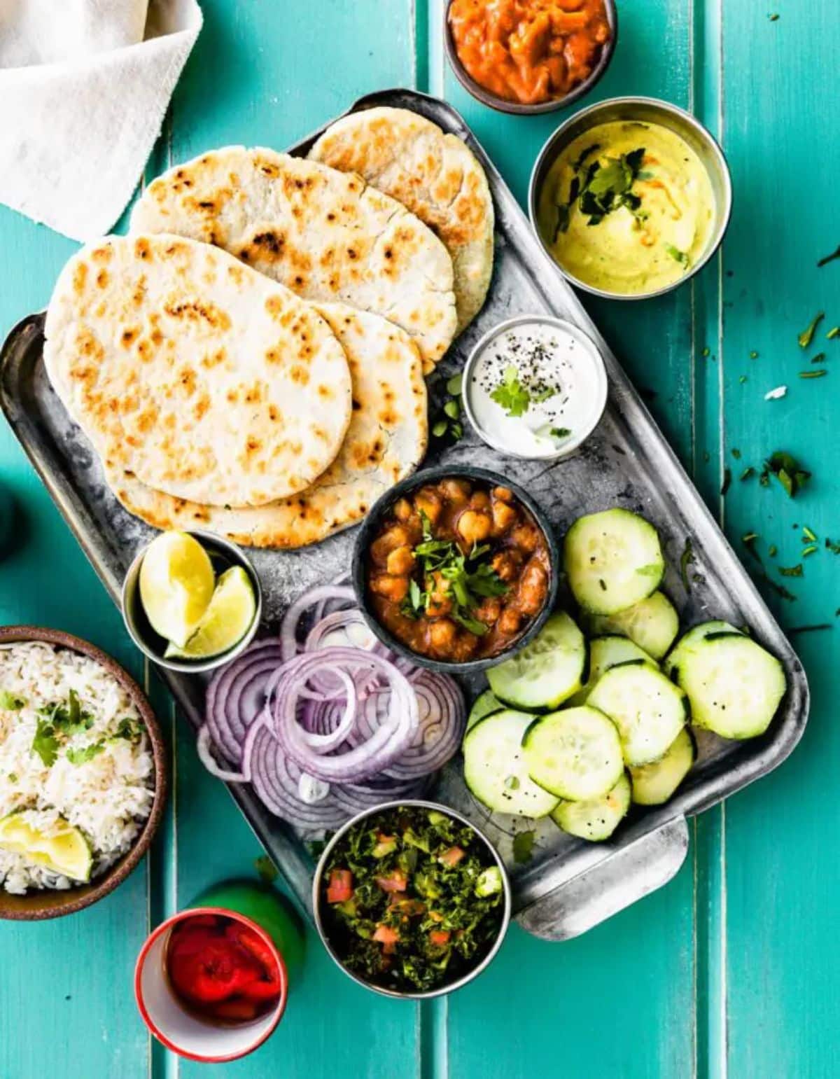 Cassava Flour Naan Bread with chopped veggies on a tray.