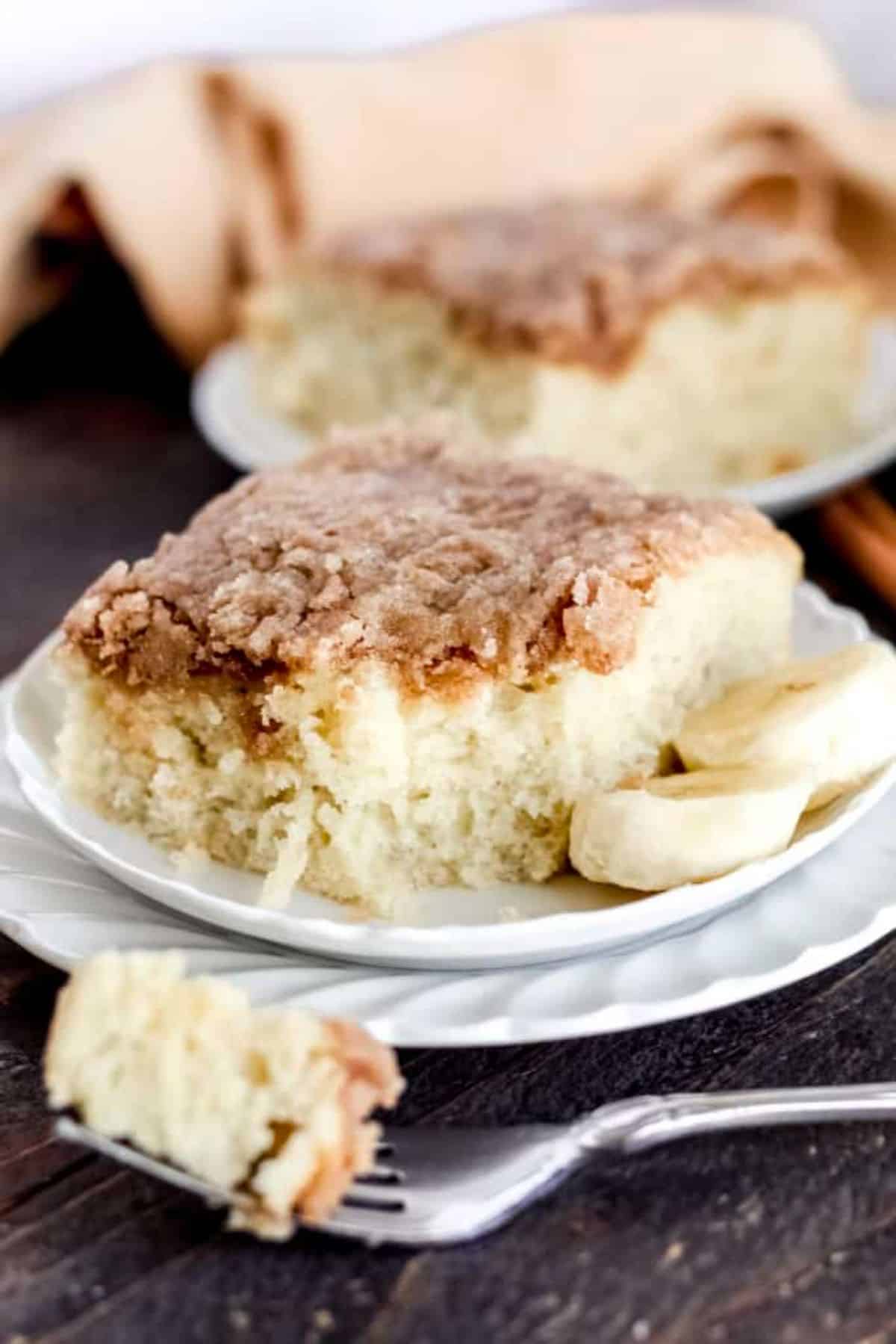 A piece of Banana Coffee Cake on a white plate.